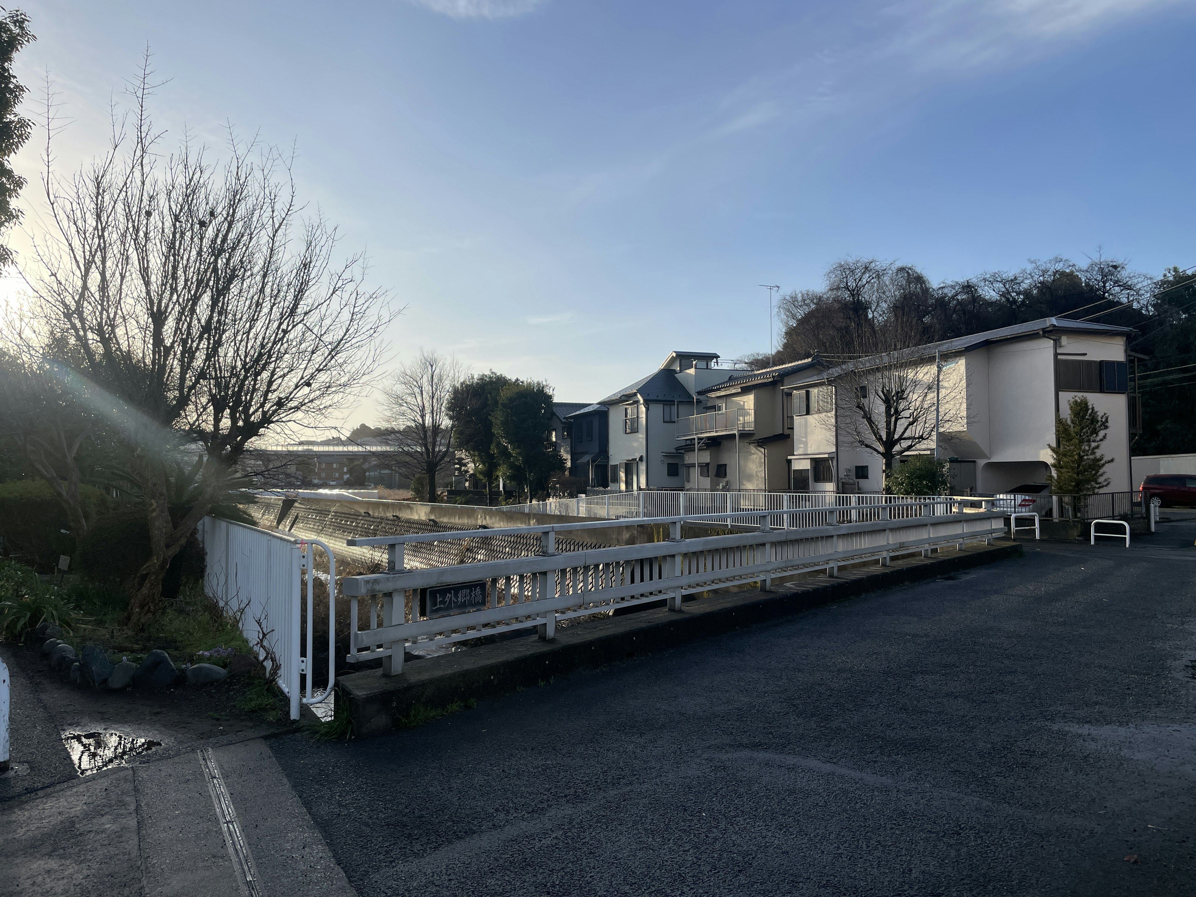 View of a residential area with white fence and buildings