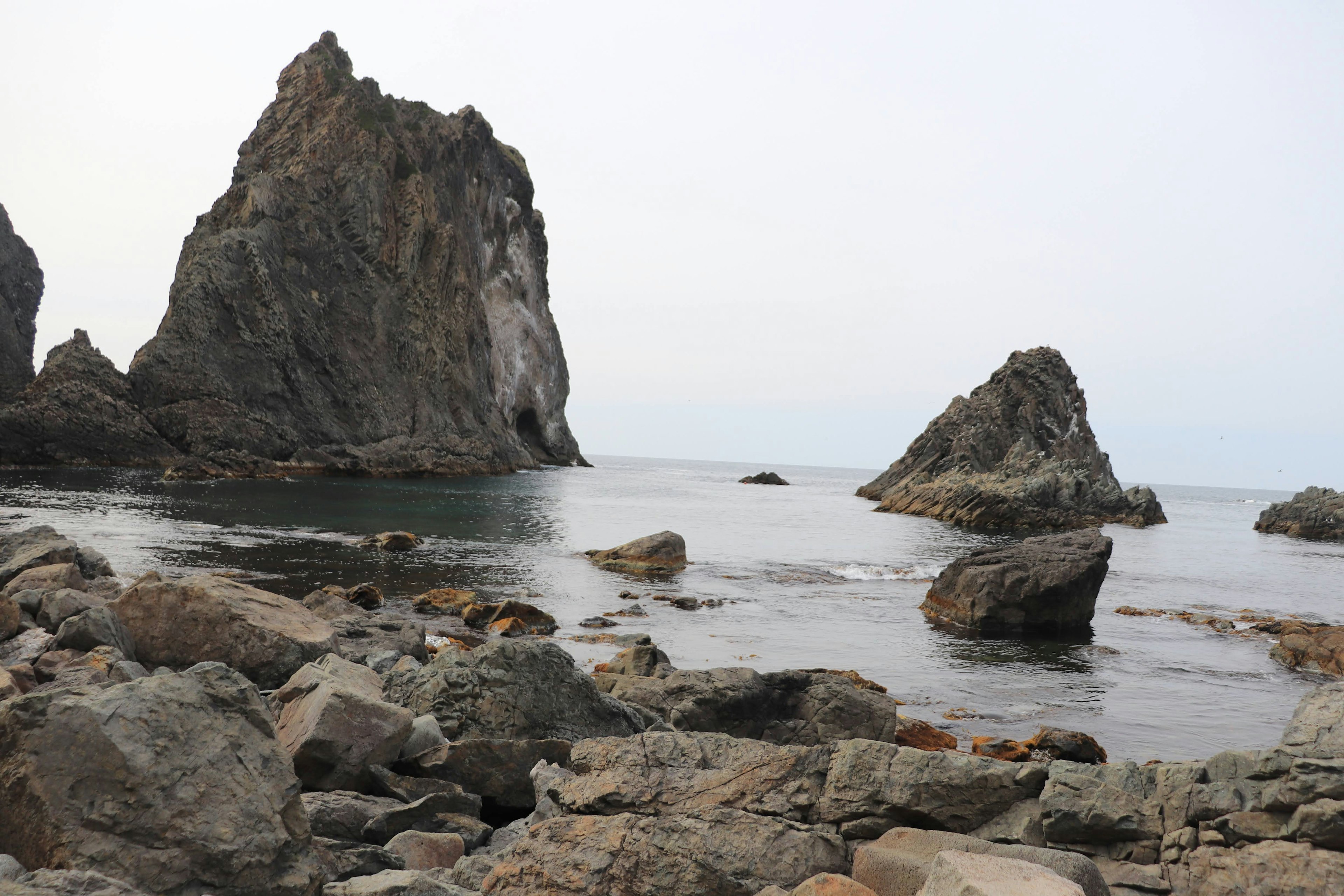 Coastal landscape featuring rock formations and calm sea