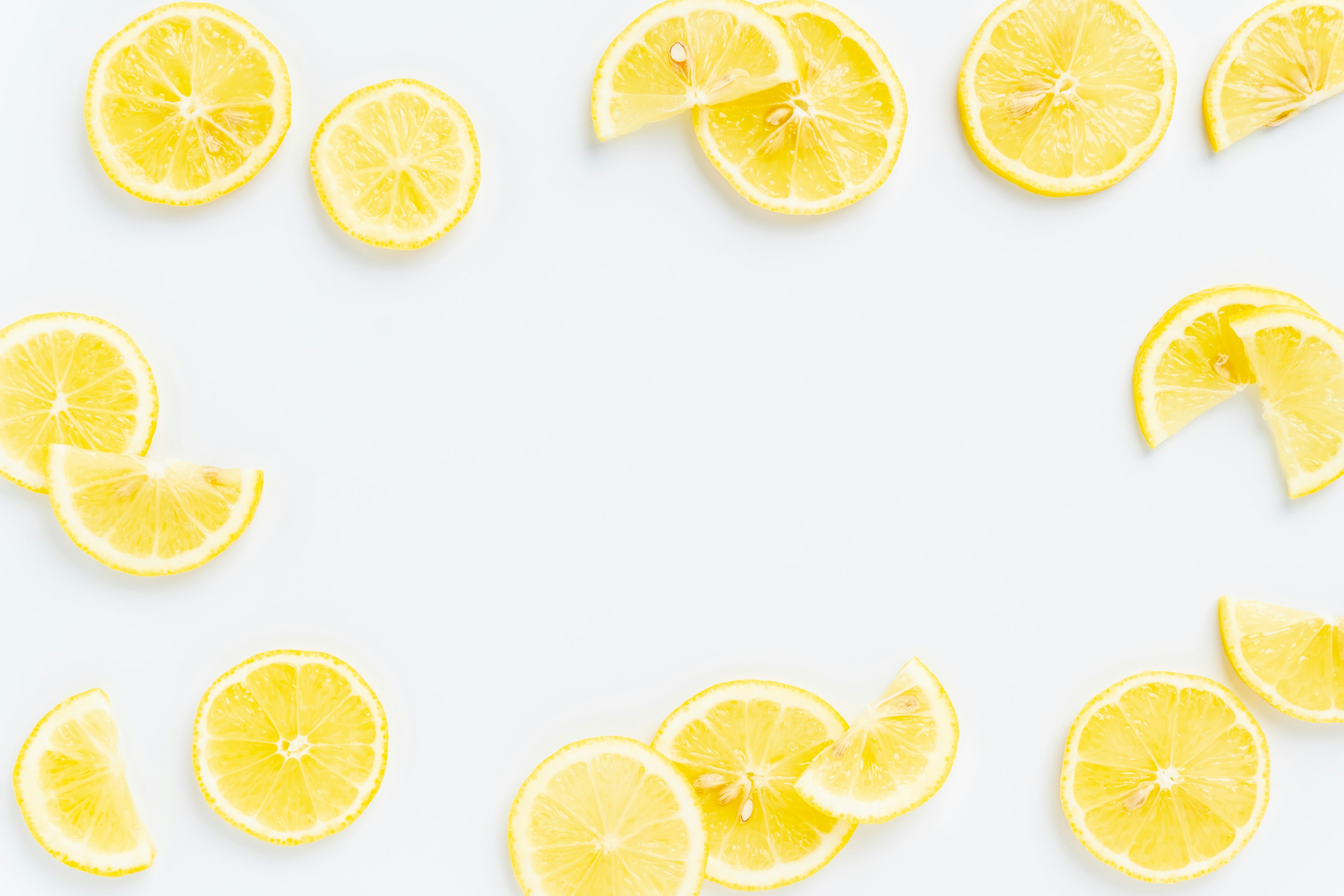 Sliced lemons arranged on a white background