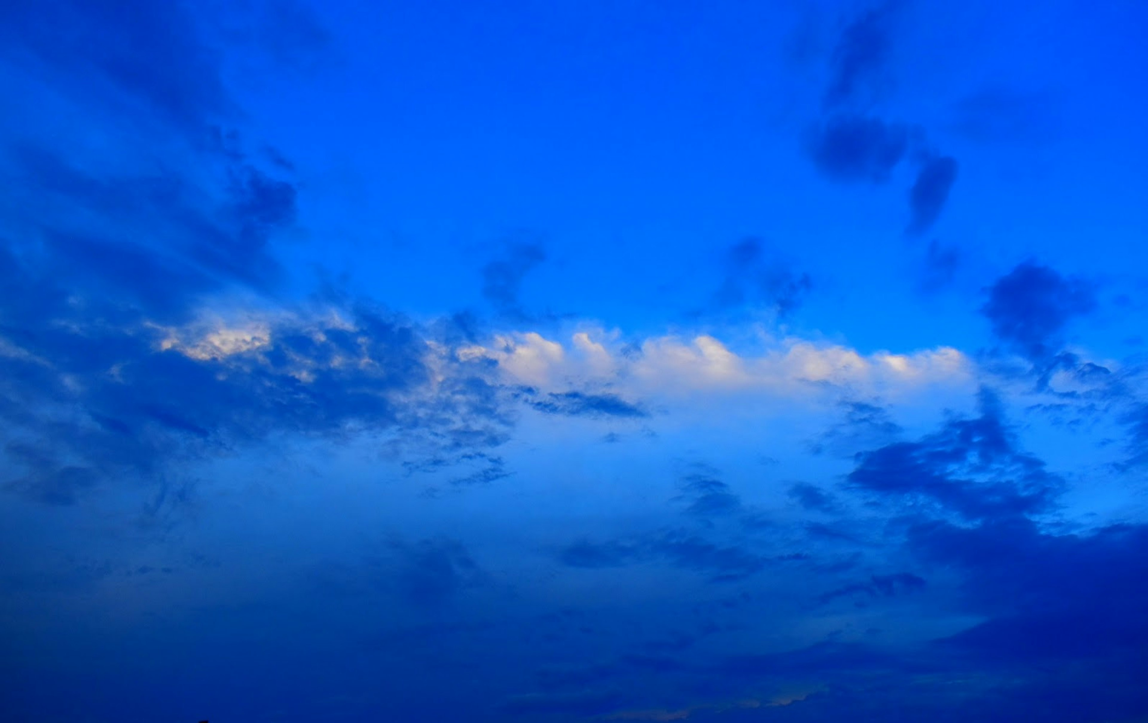 Contrast of white clouds against a deep blue sky