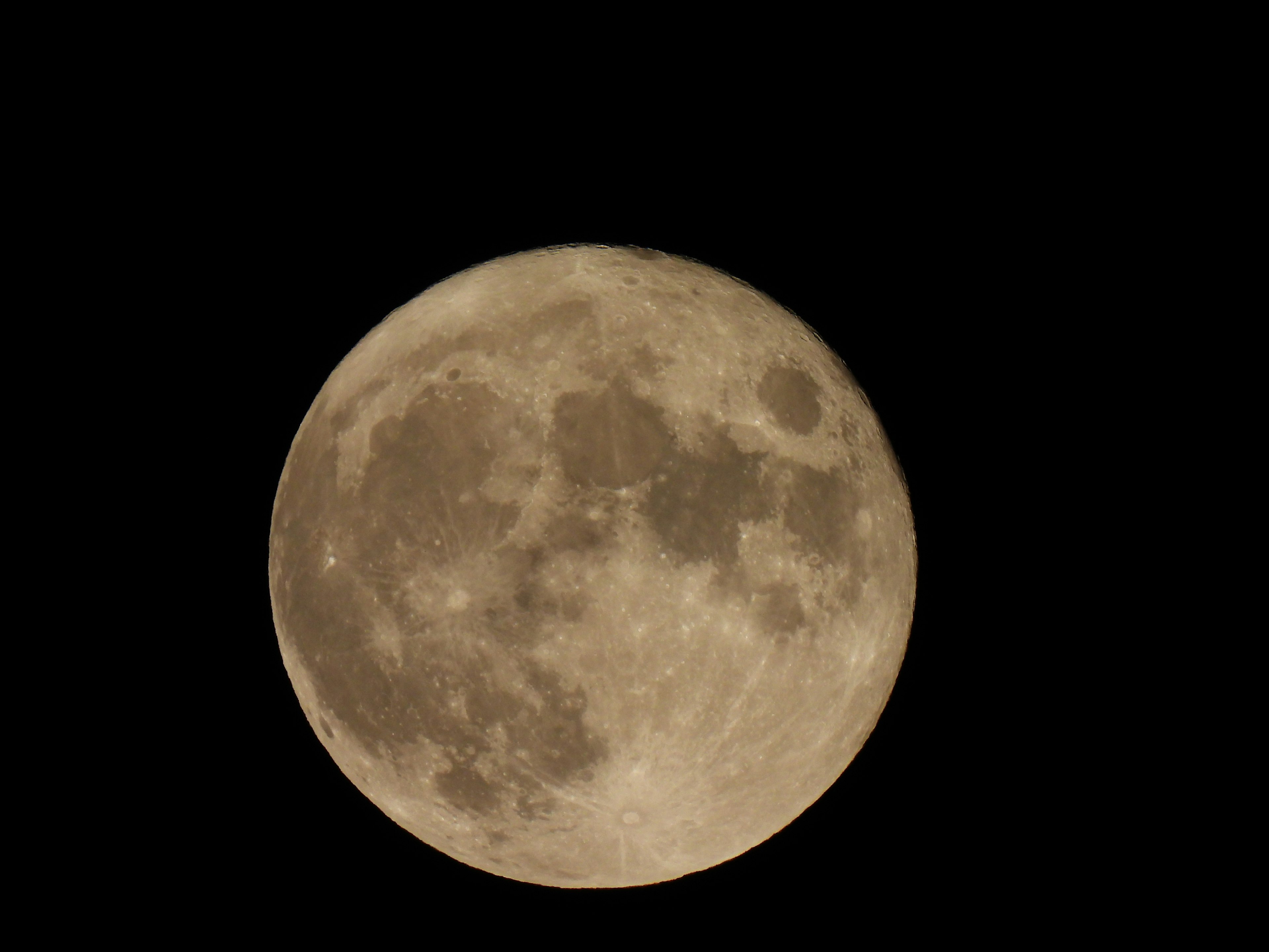 Close-up of a bright full moon in the night sky