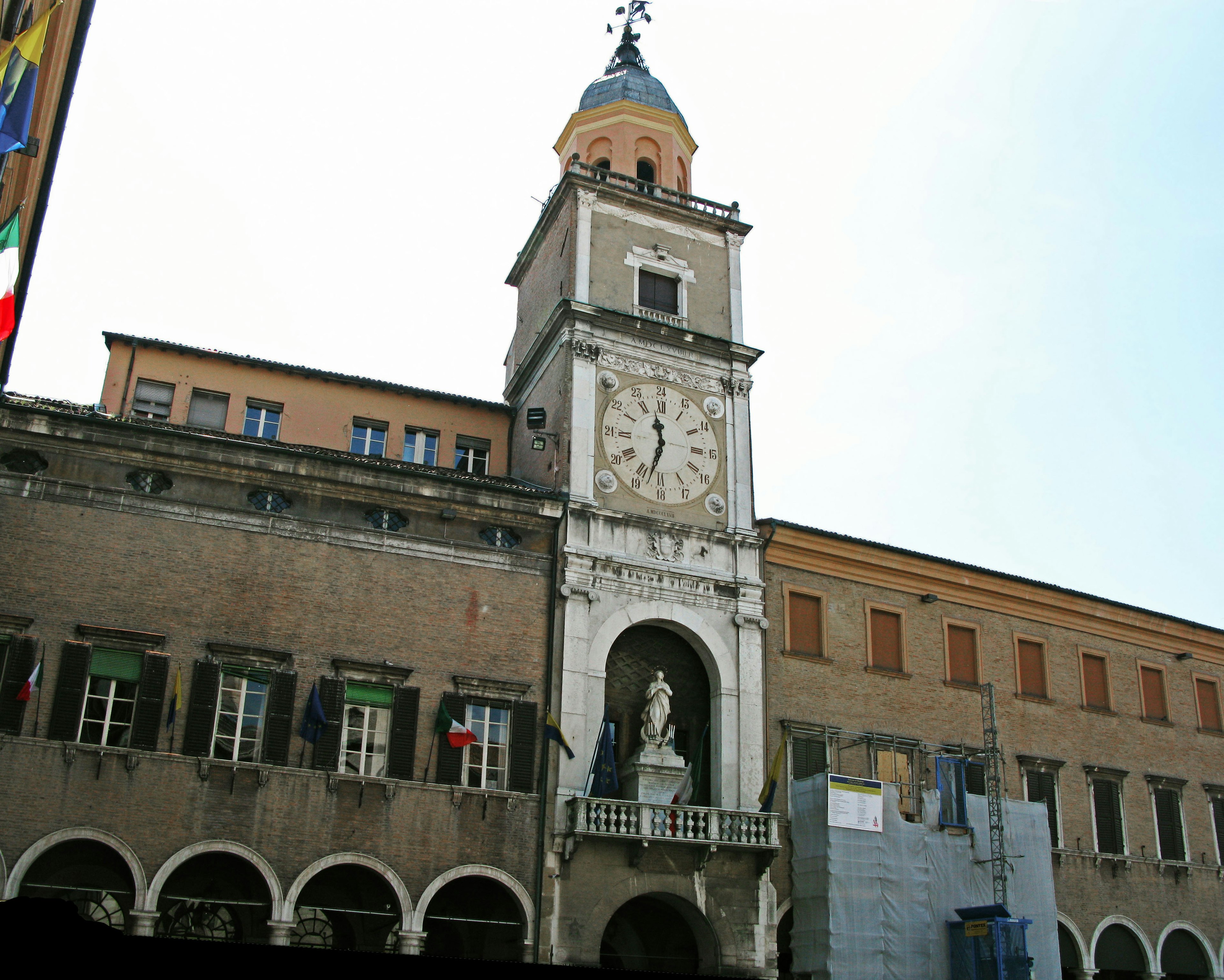 Historical clock tower and building facade in Modena square