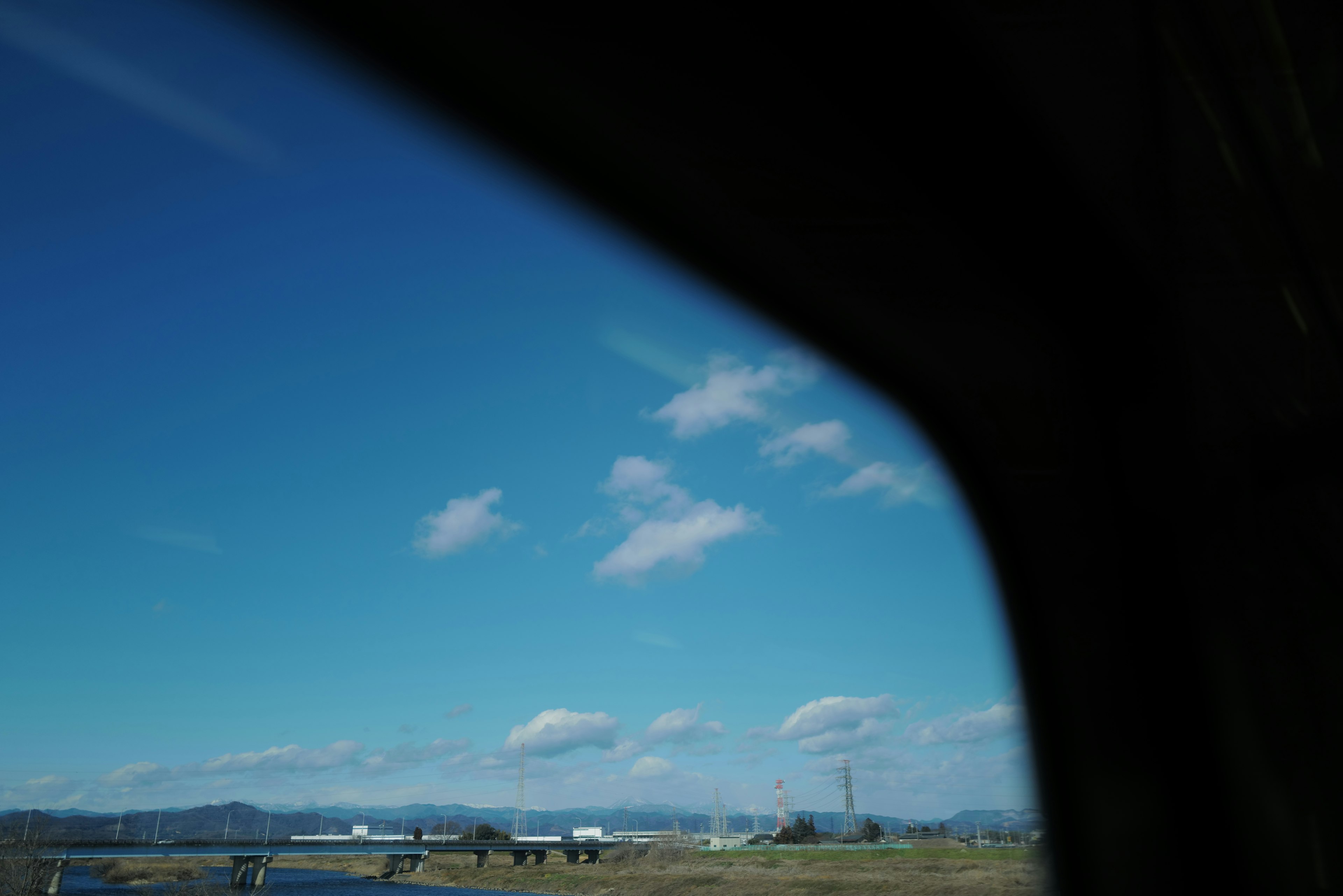 窓越しに見える青空と白い雲の風景