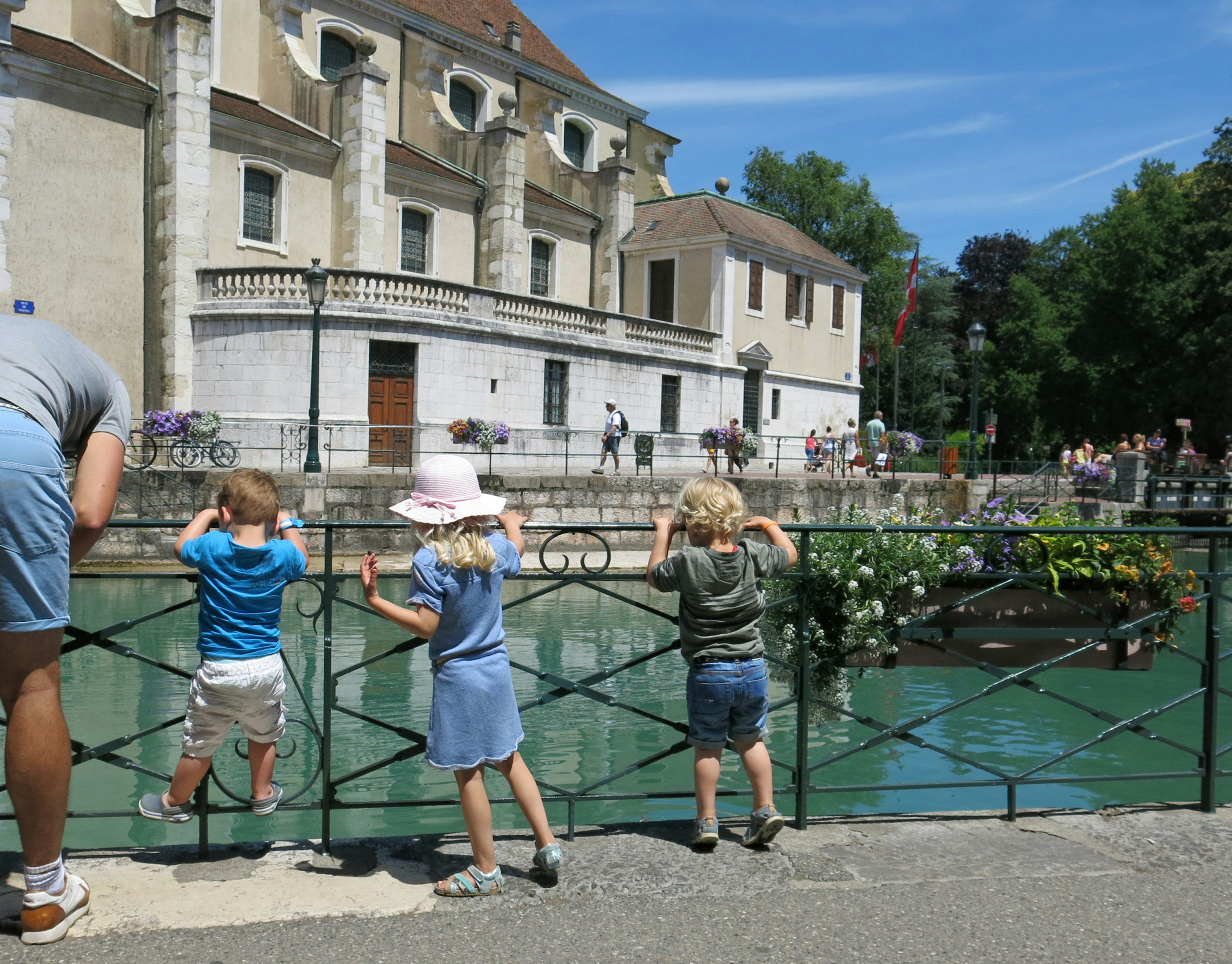 Children gazing at the river in a scenic setting