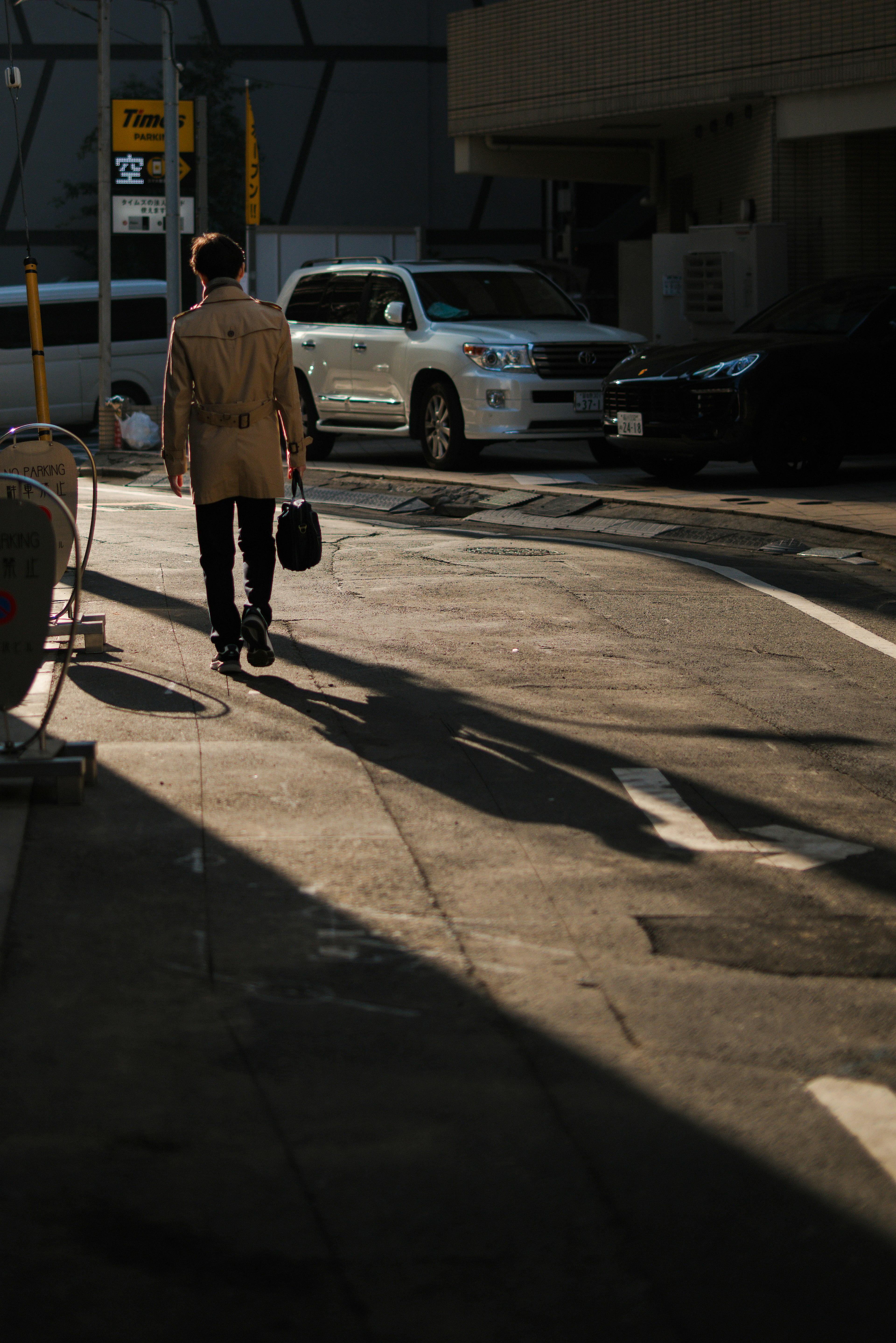 Hombre de negocios caminando por la calle con un maletín y su sombra