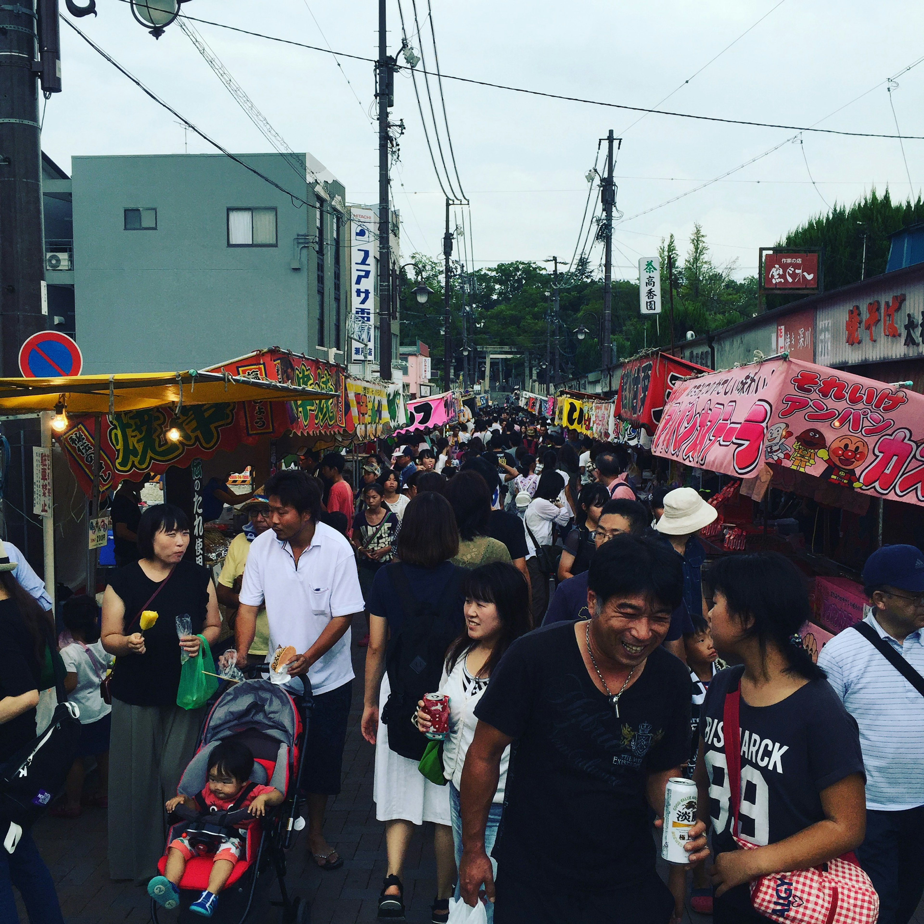 Crowded street market with food stalls and people gathering