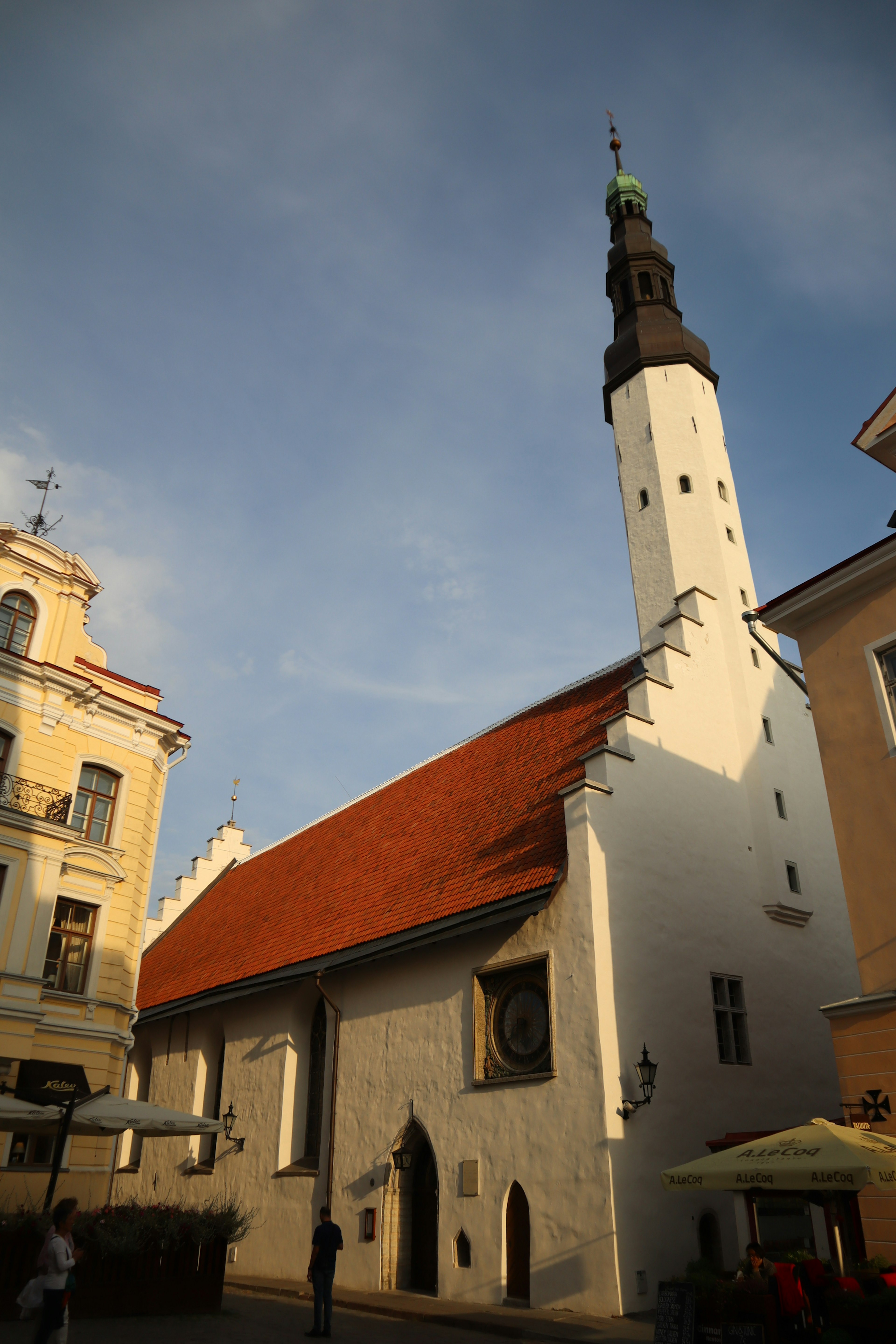 Historic church with white walls and red roof under a blue sky