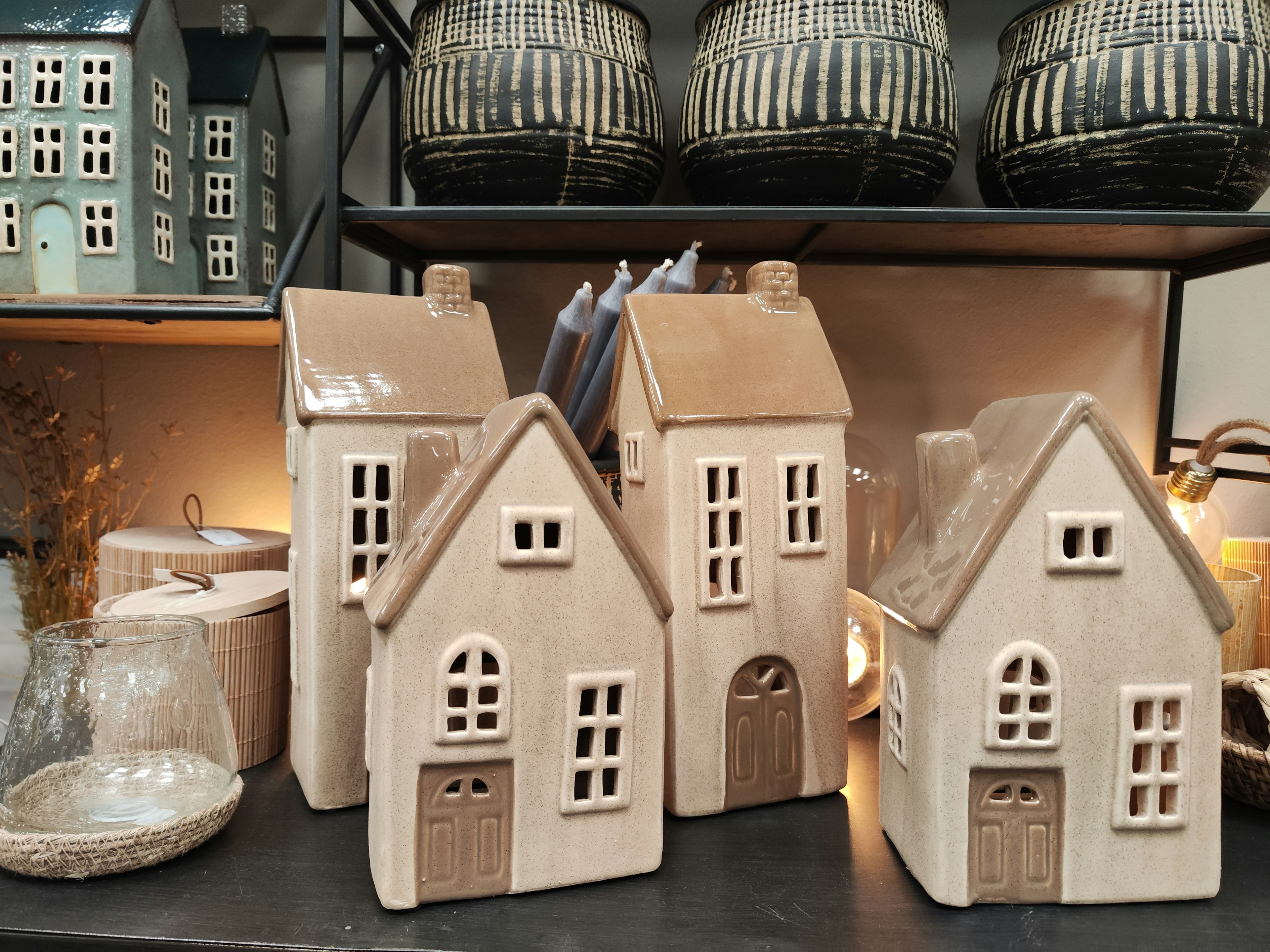 Decorative ceramic houses arranged on a shelf