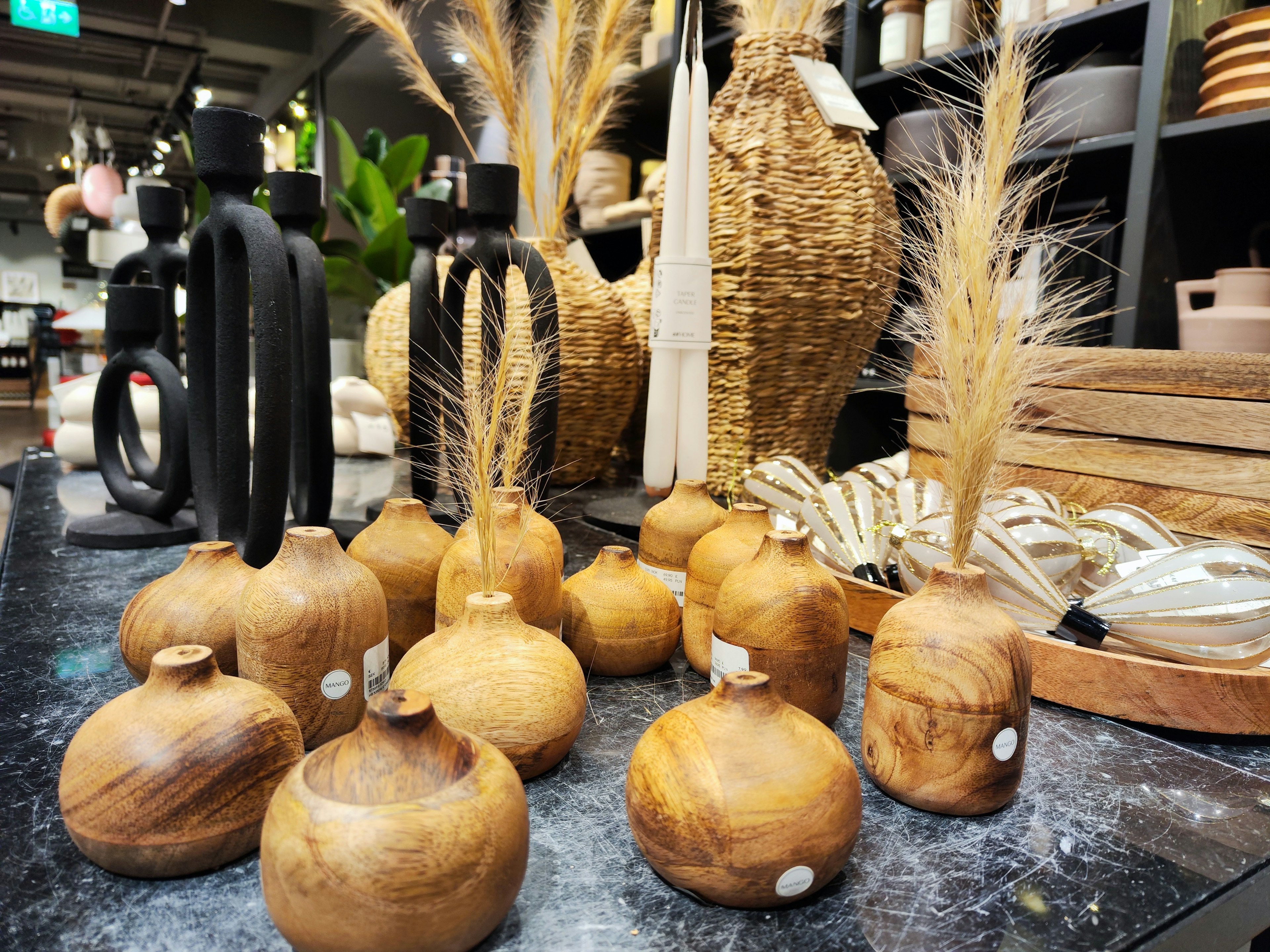 Wooden decorative items and dried plant arrangements displayed