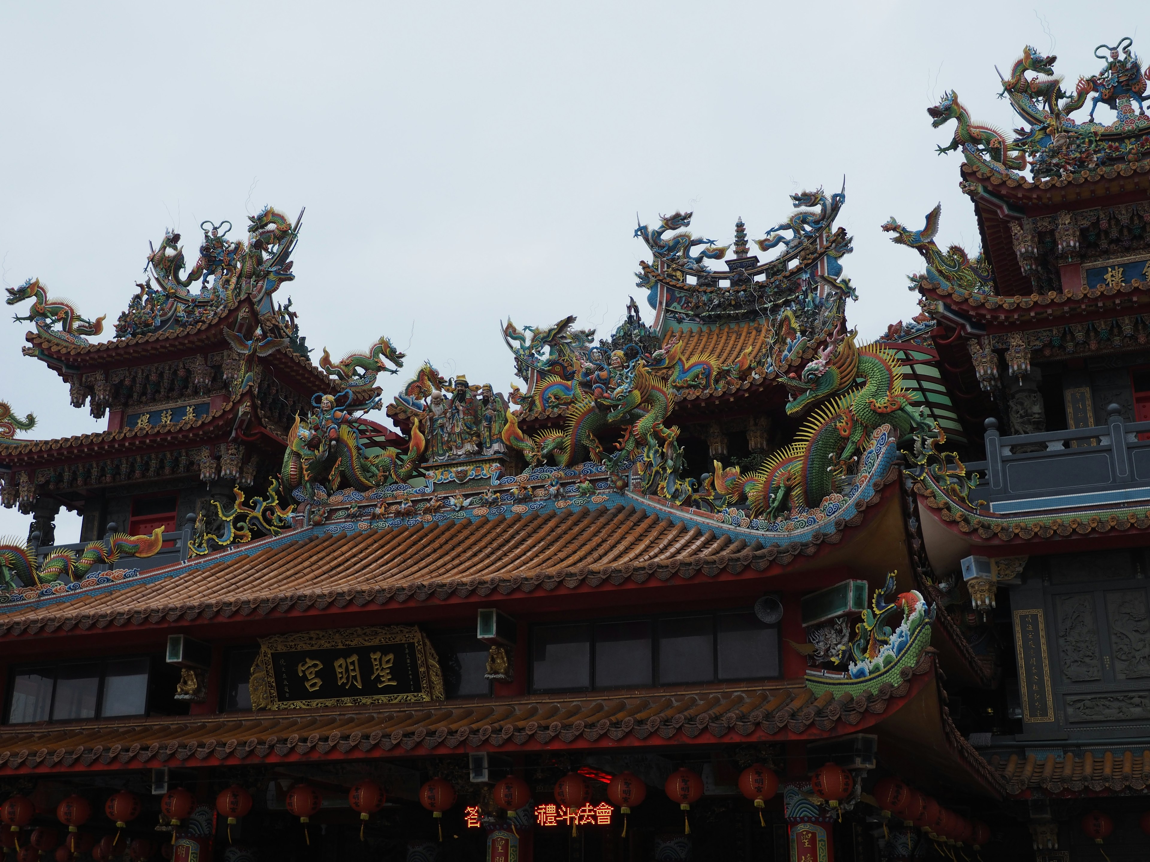 色彩斑斓的寺庙屋顶，装饰精美，有龙和神话生物的雕刻