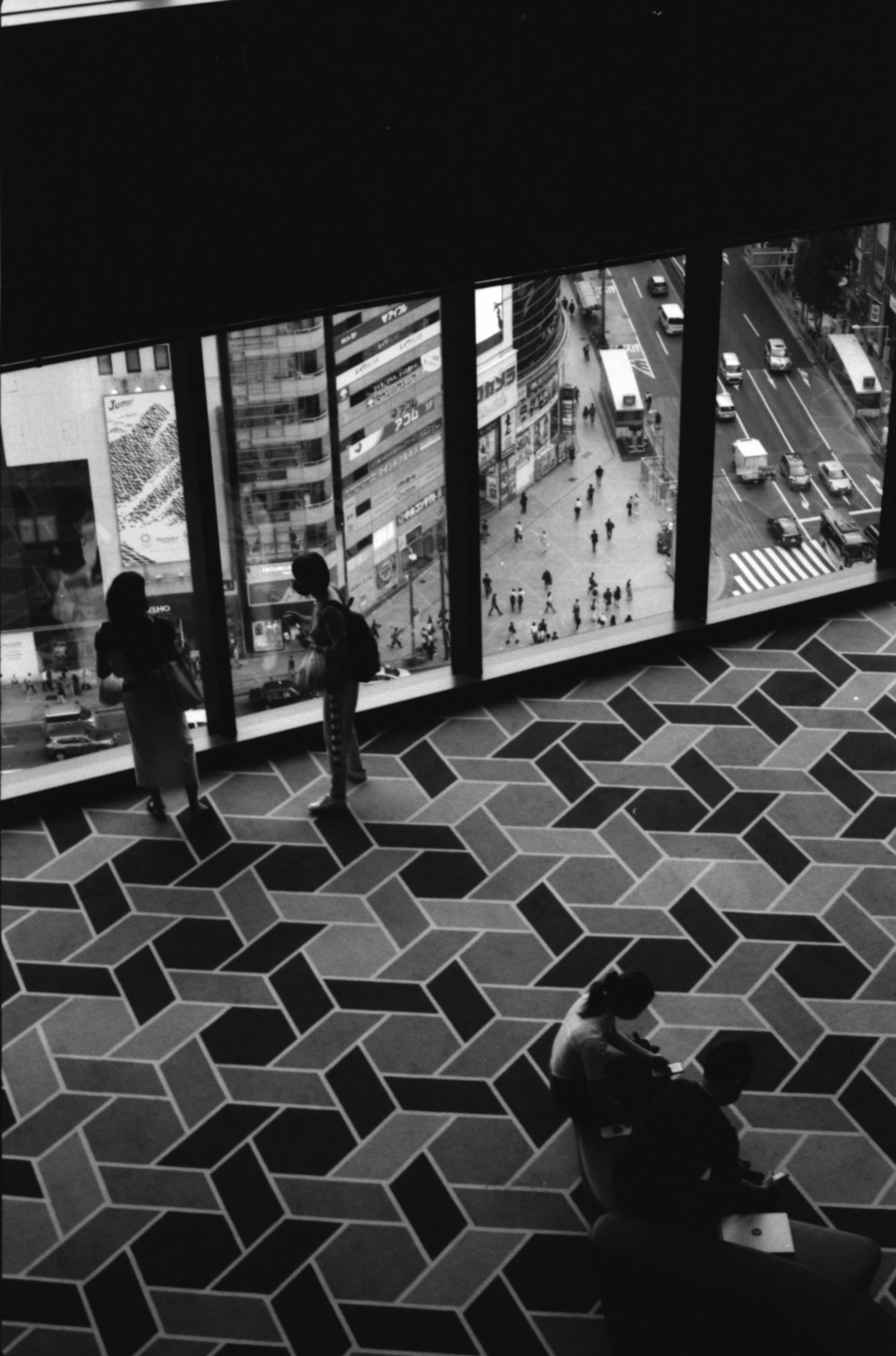 City view from high-rise building window with unique patterned floor