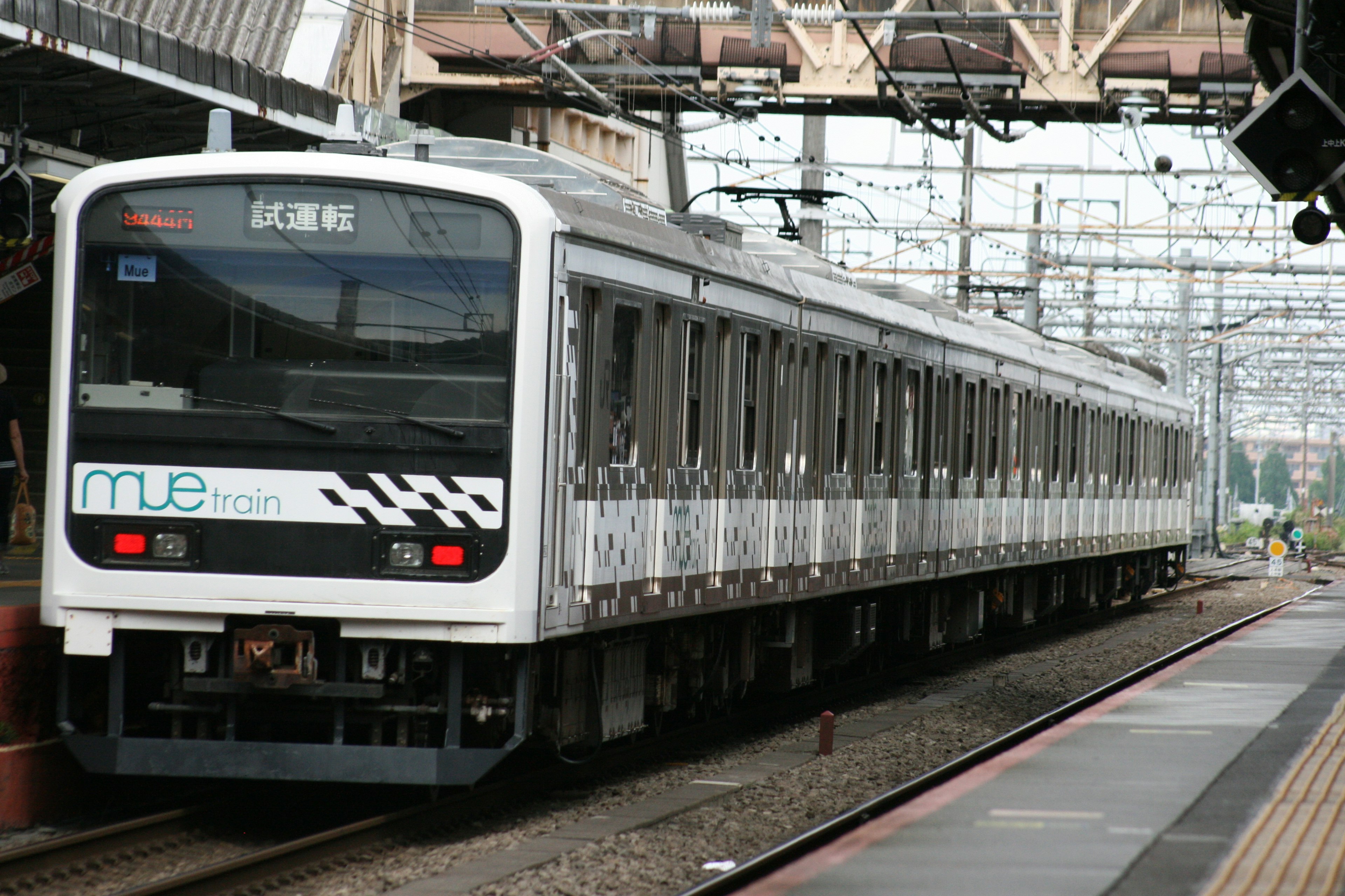 Sebuah kereta putih berhenti di stasiun