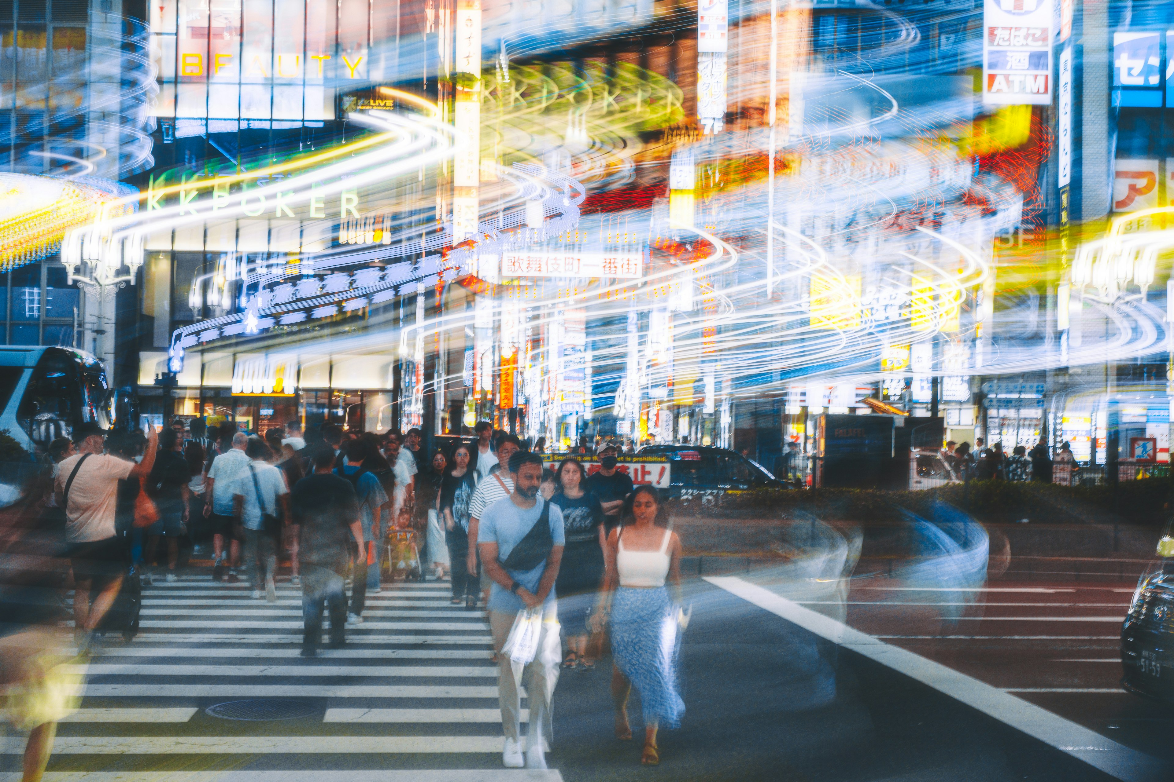 Busy intersection with pedestrians and bright neon lights