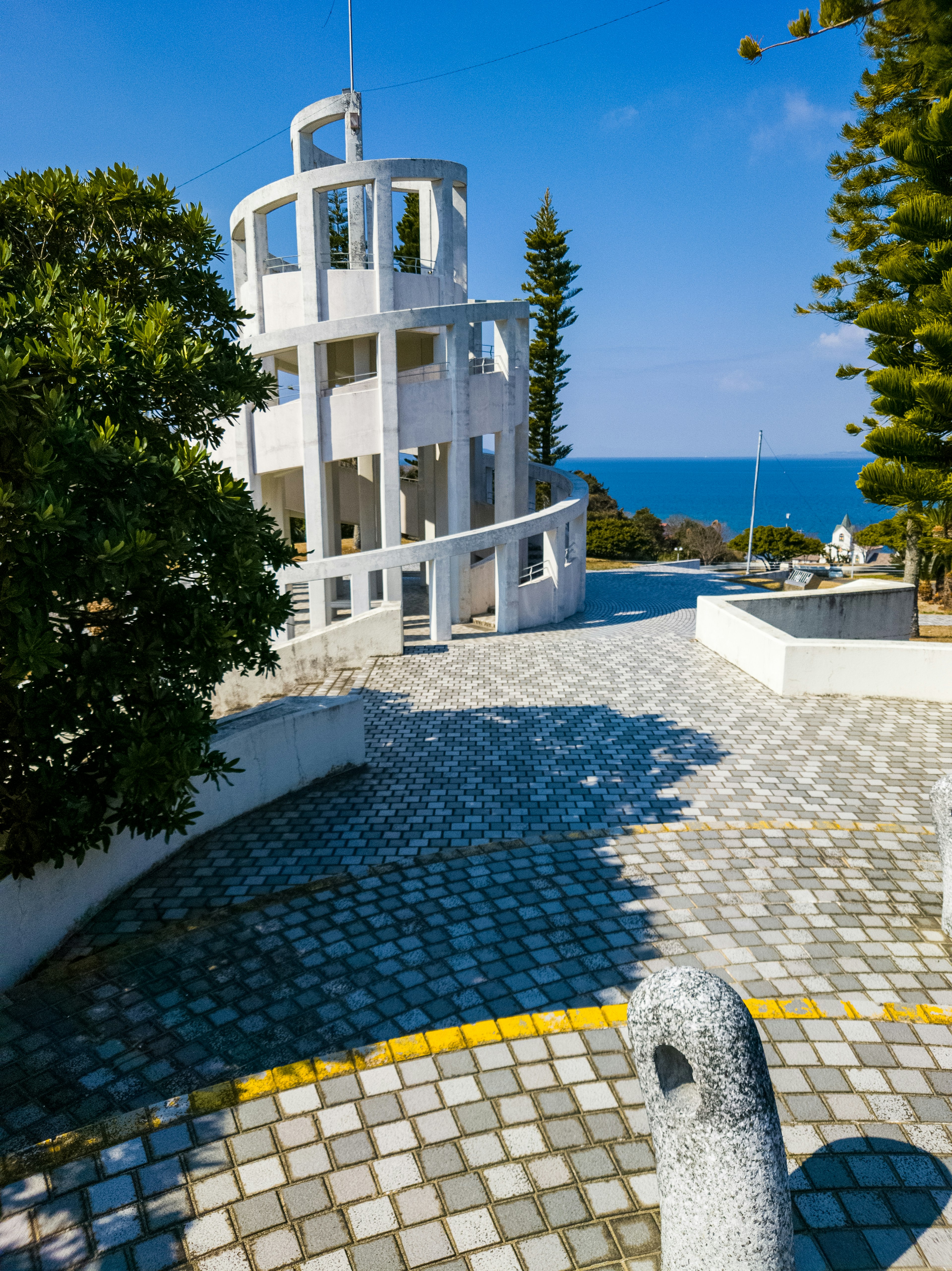 Scenic view of a white spiral staircase building overlooking the sea