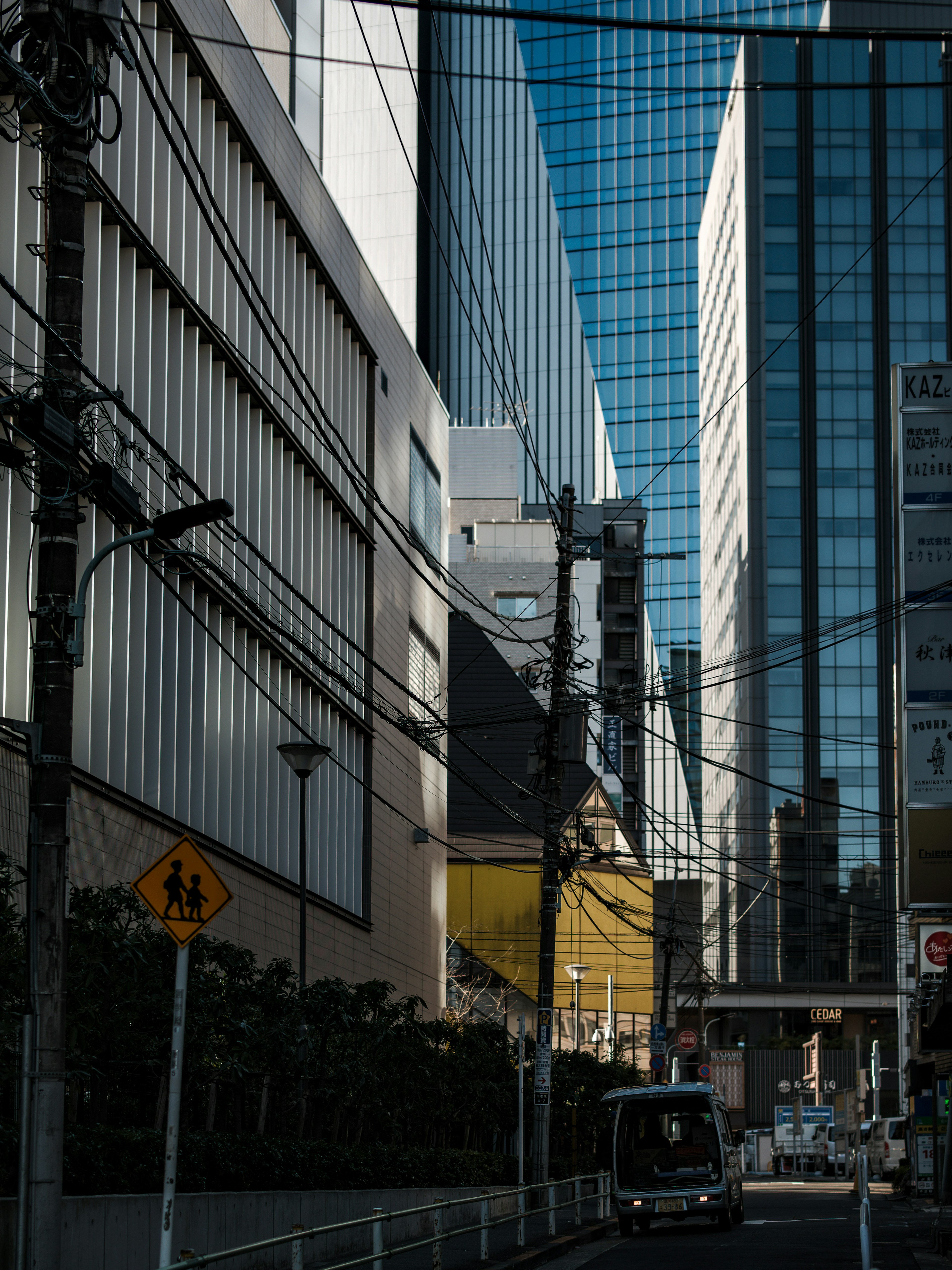 Urban landscape with towering buildings reflecting blue sky