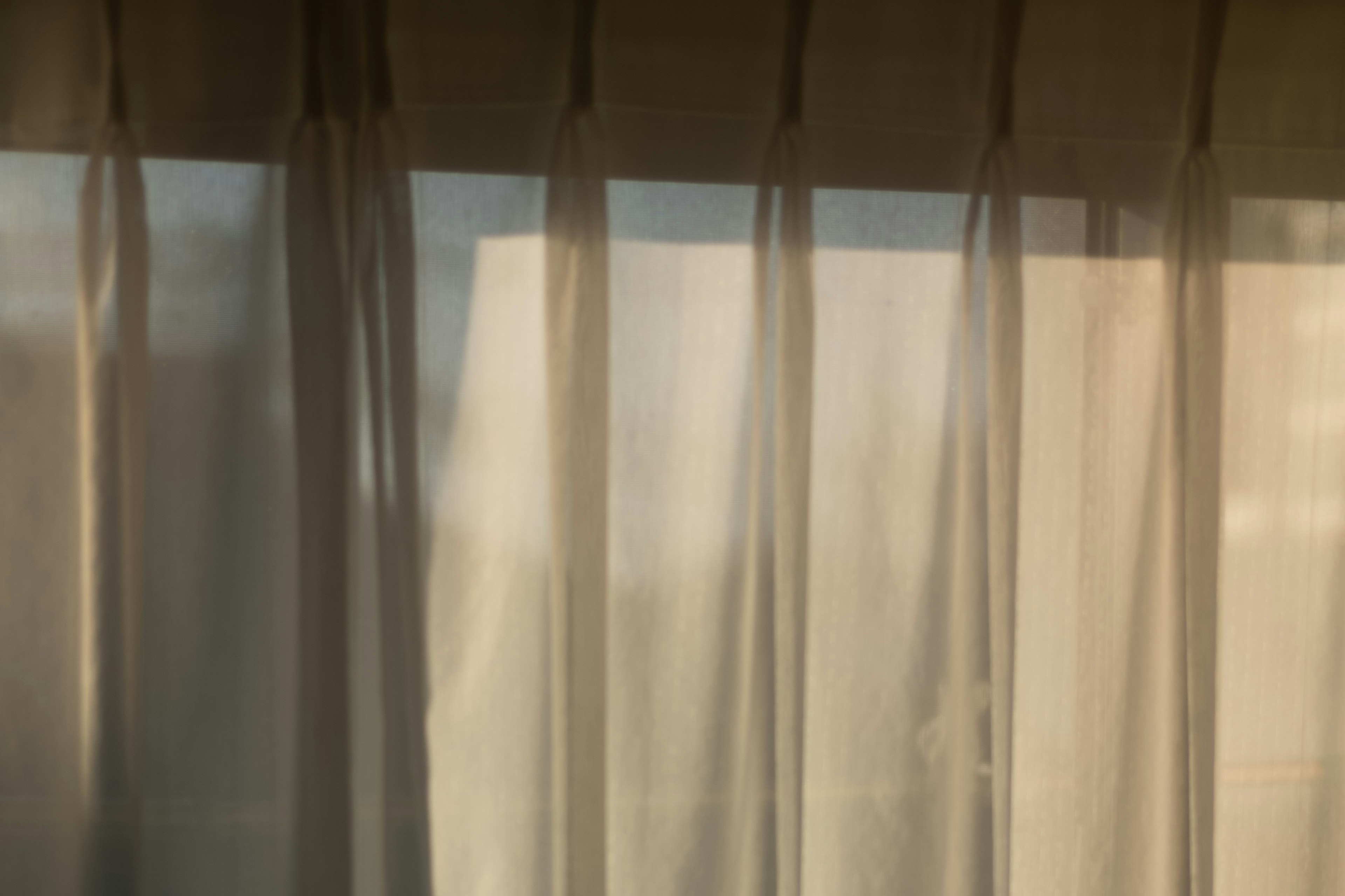 Soft light and outdoor view seen through sheer curtains