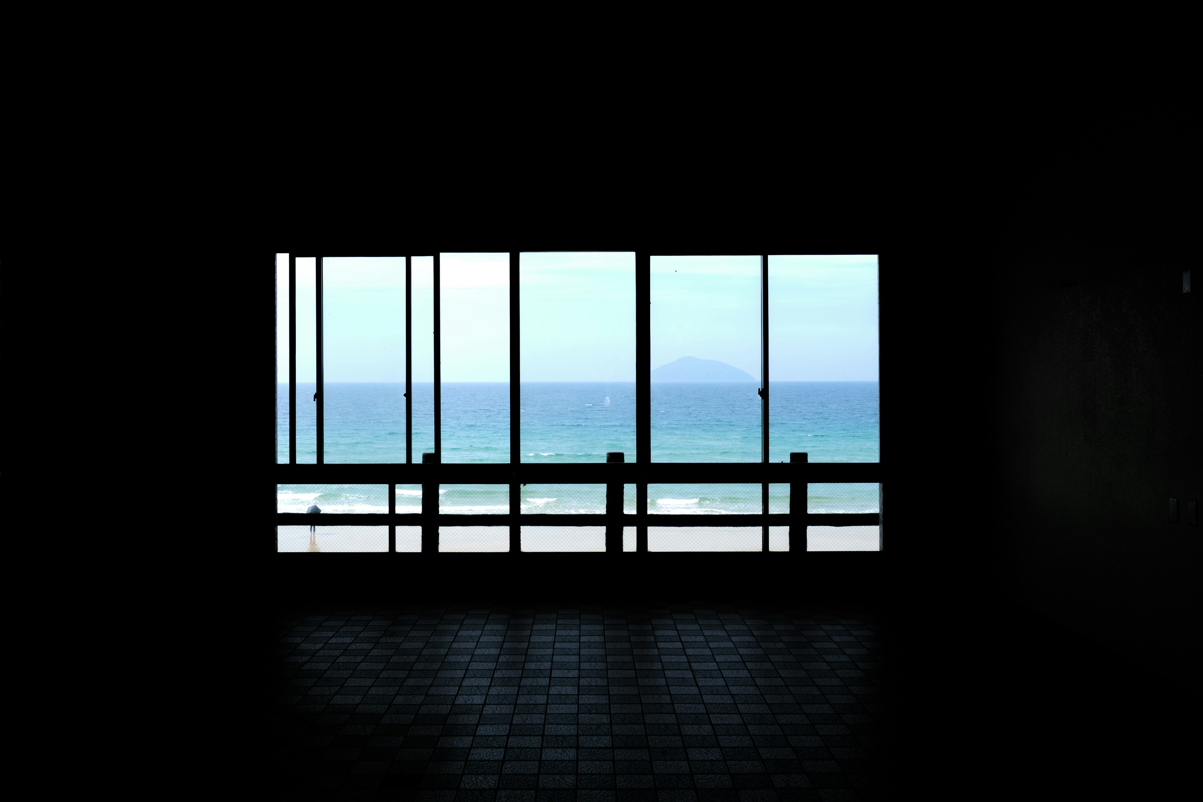 Interior view of a window showcasing a beach scene