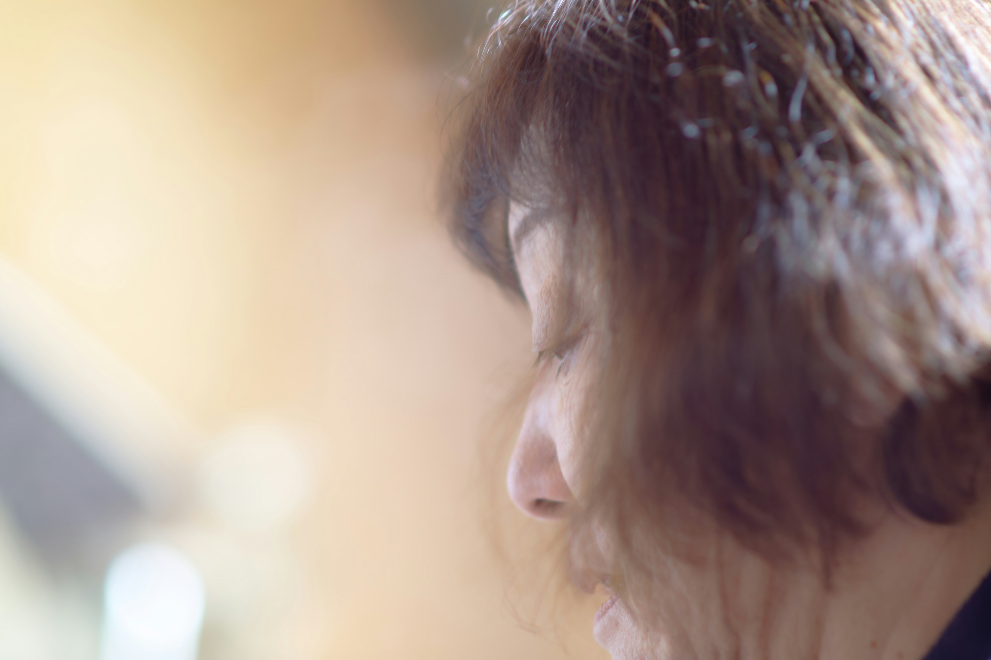 Close-up of a woman’s profile softly illuminated with warm light