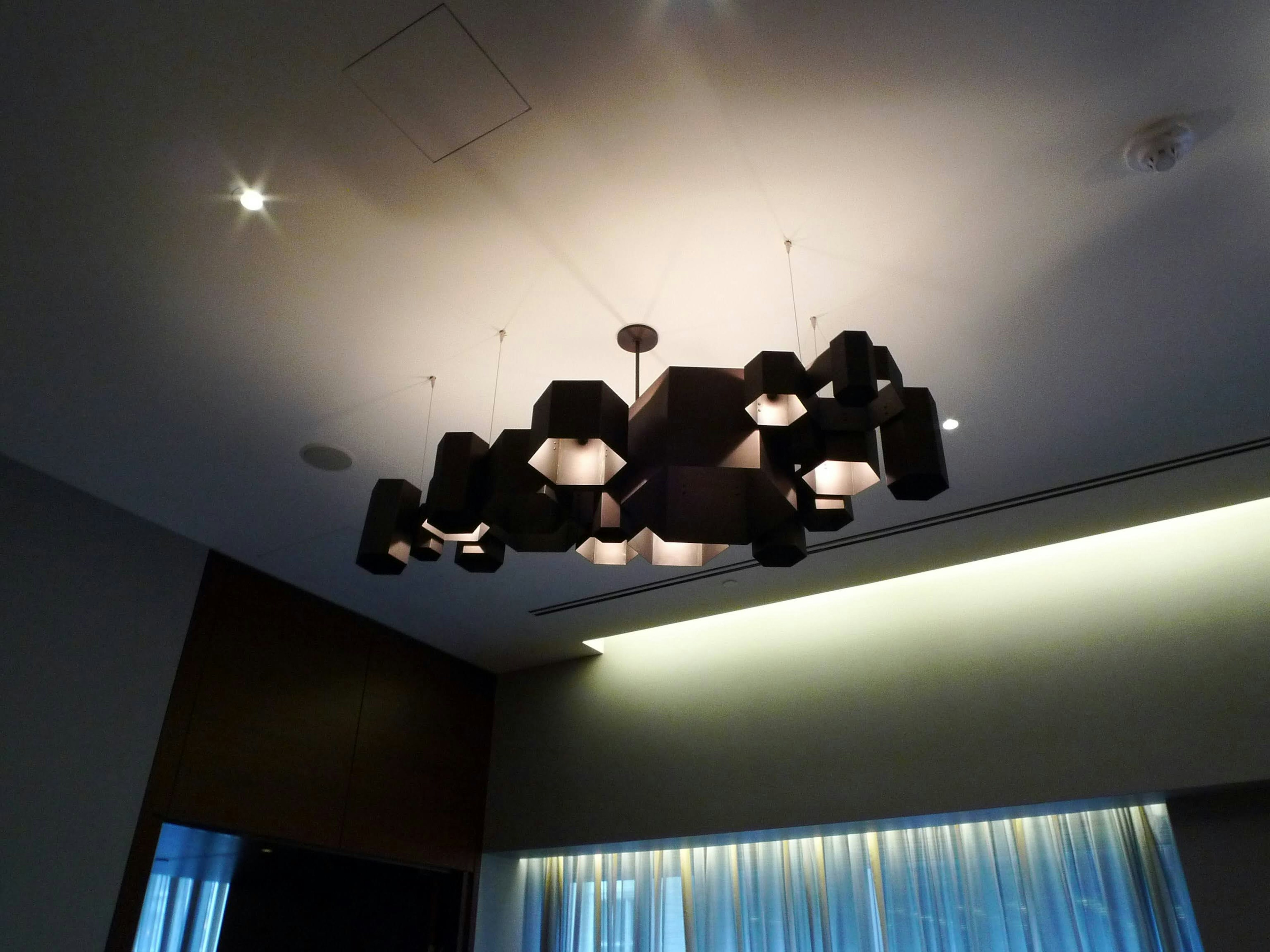 Modern interior featuring a black chandelier hanging from the ceiling