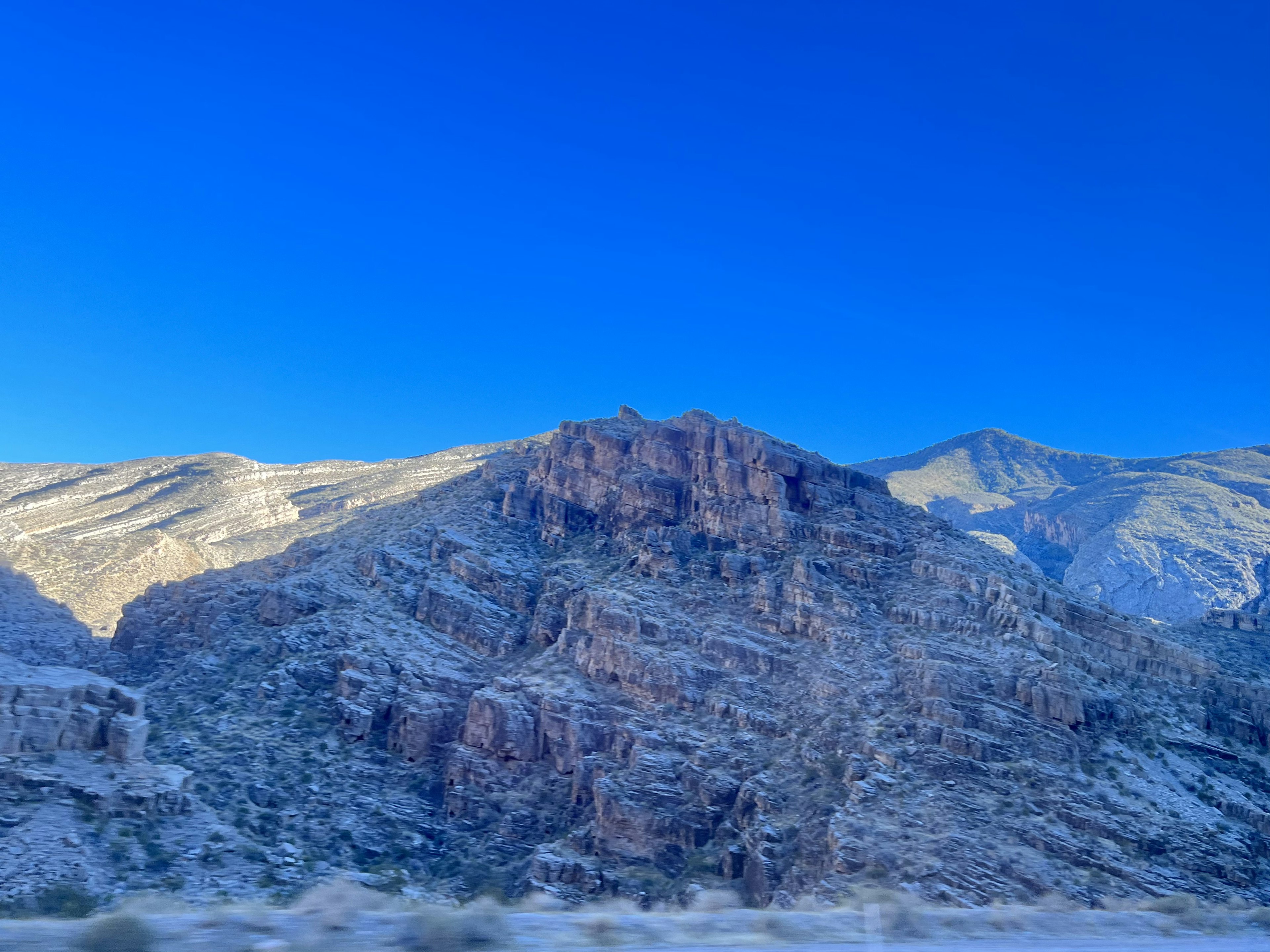 Rocky mountain landscape under a clear blue sky and dry terrain