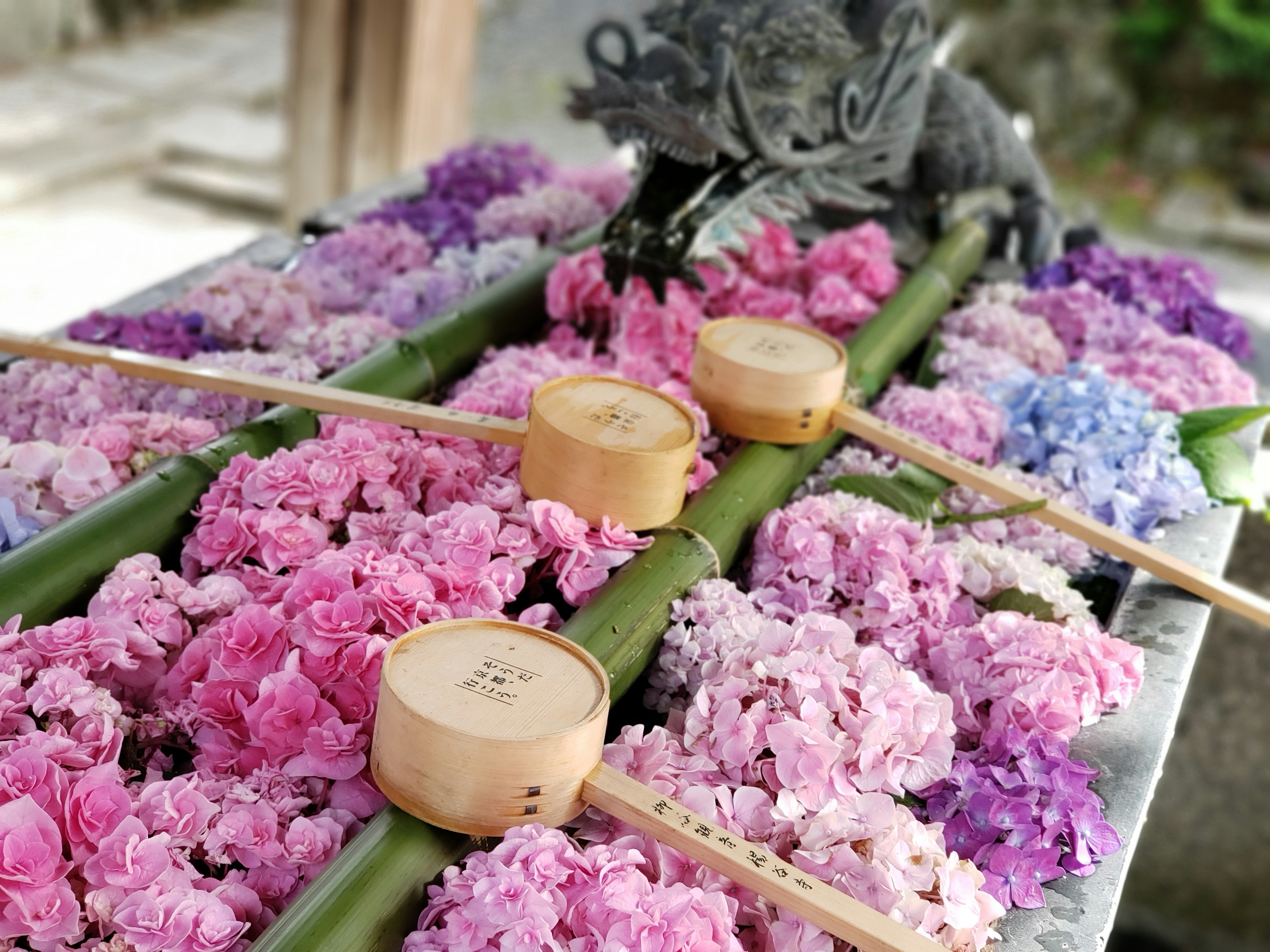 Traditional altar adorned with colorful flowers and bamboo vessels