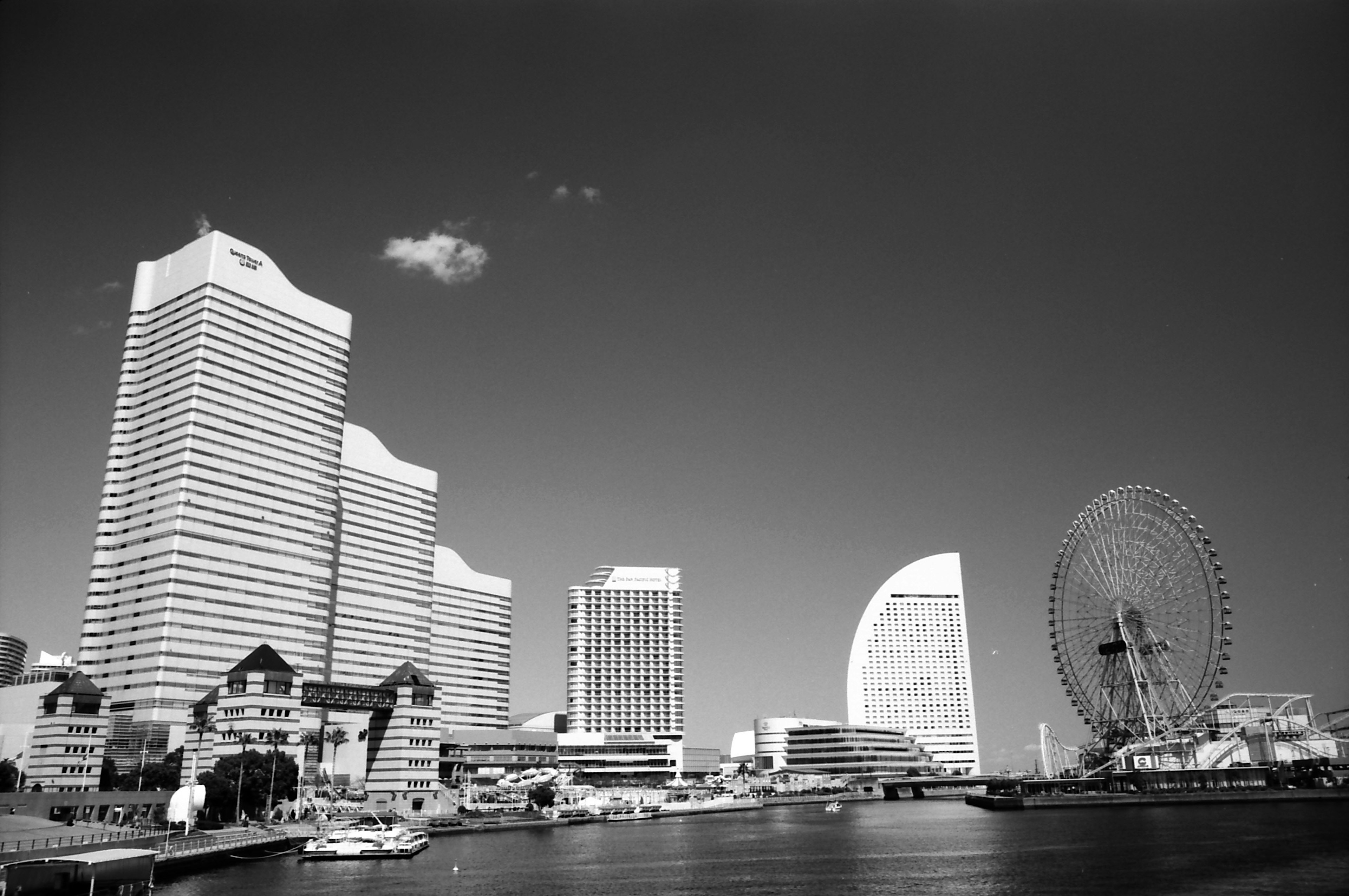 Monochrome view of Yokohama's modern skyline with a Ferris wheel