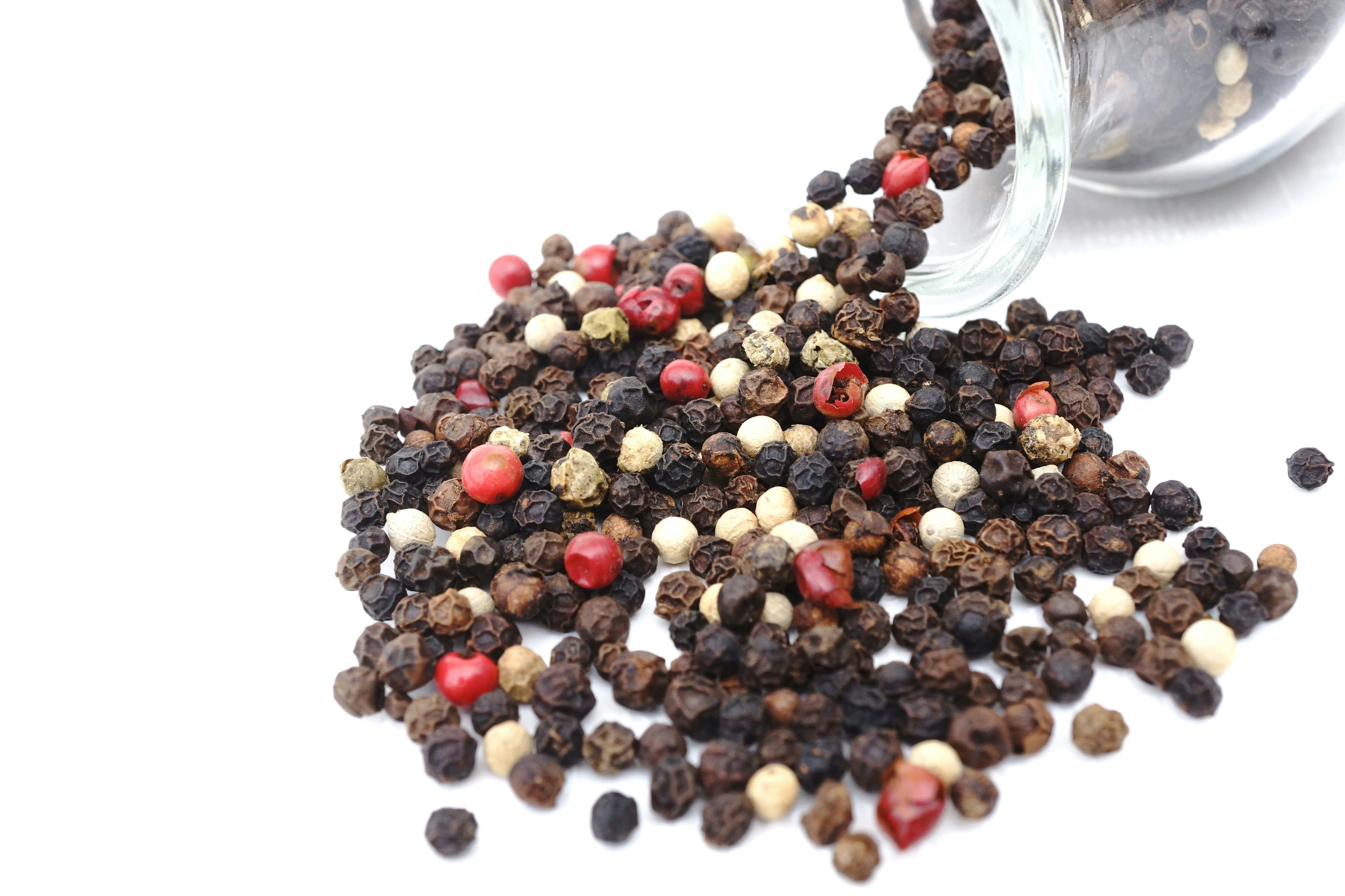 Spilled multicolored peppercorns from a jar