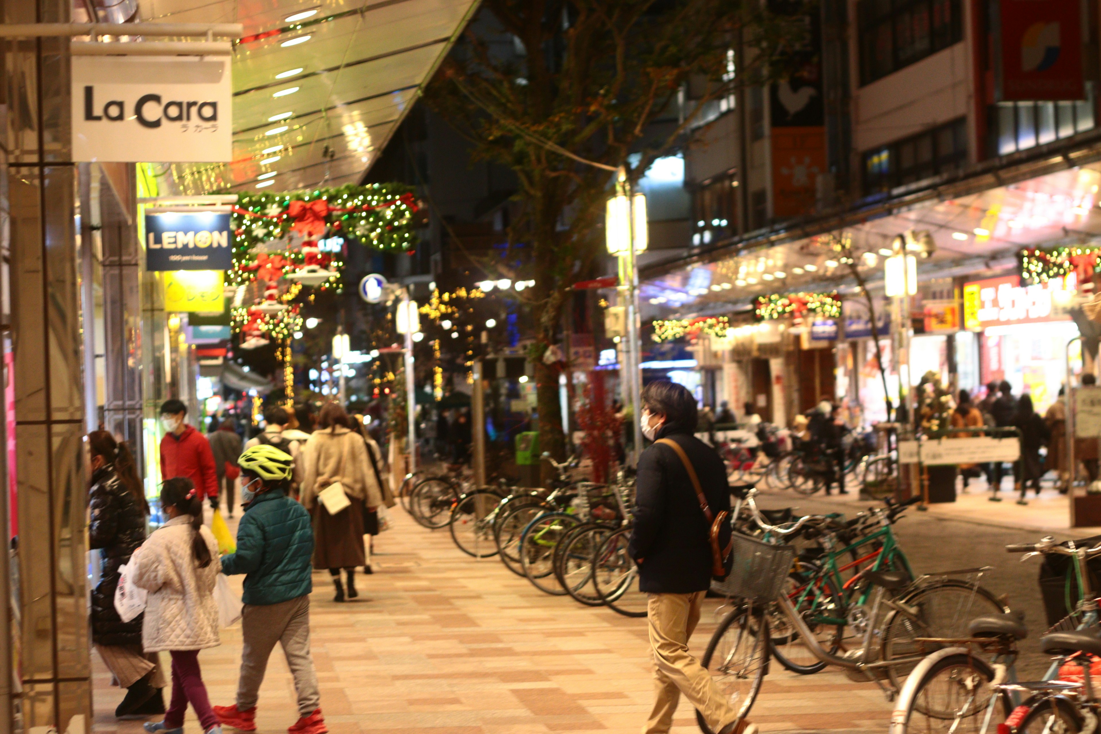 ทิวทัศน์ถนนยามค่ำคืนที่มีร้านค้าและจักรยาน