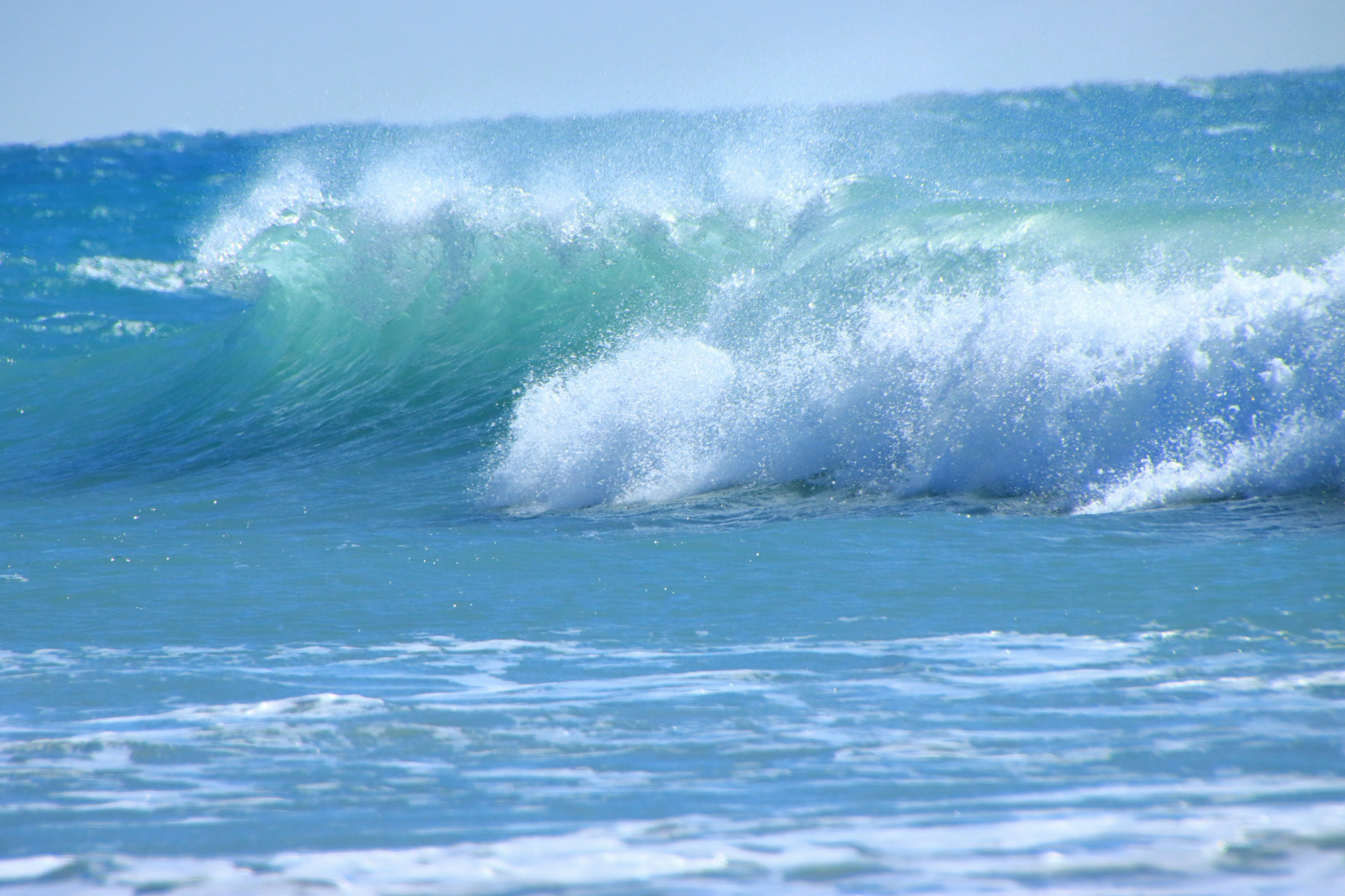 Blue ocean waves crashing with white foam