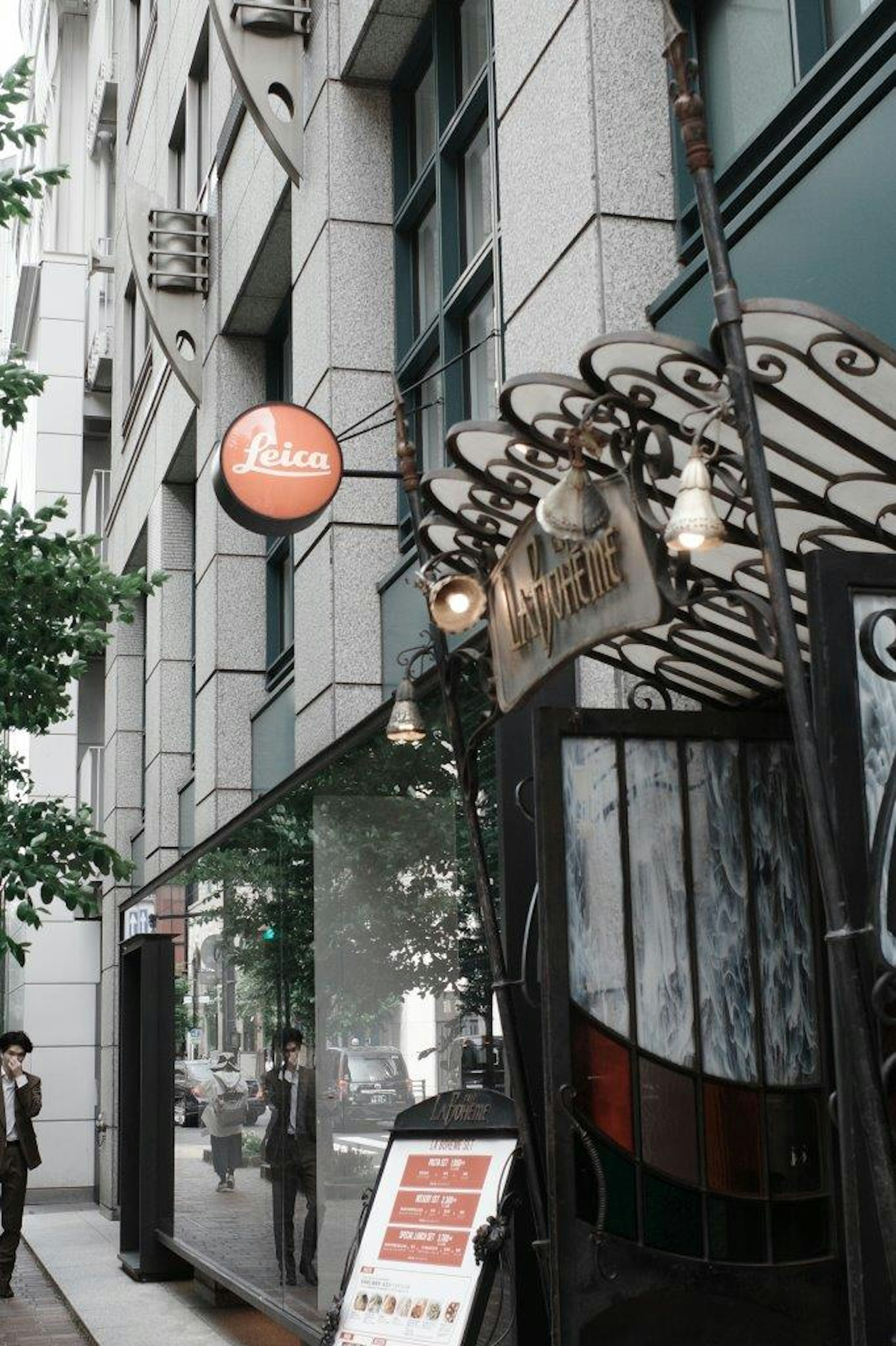 Vue de la rue avec une entrée de café et la façade d'un bâtiment