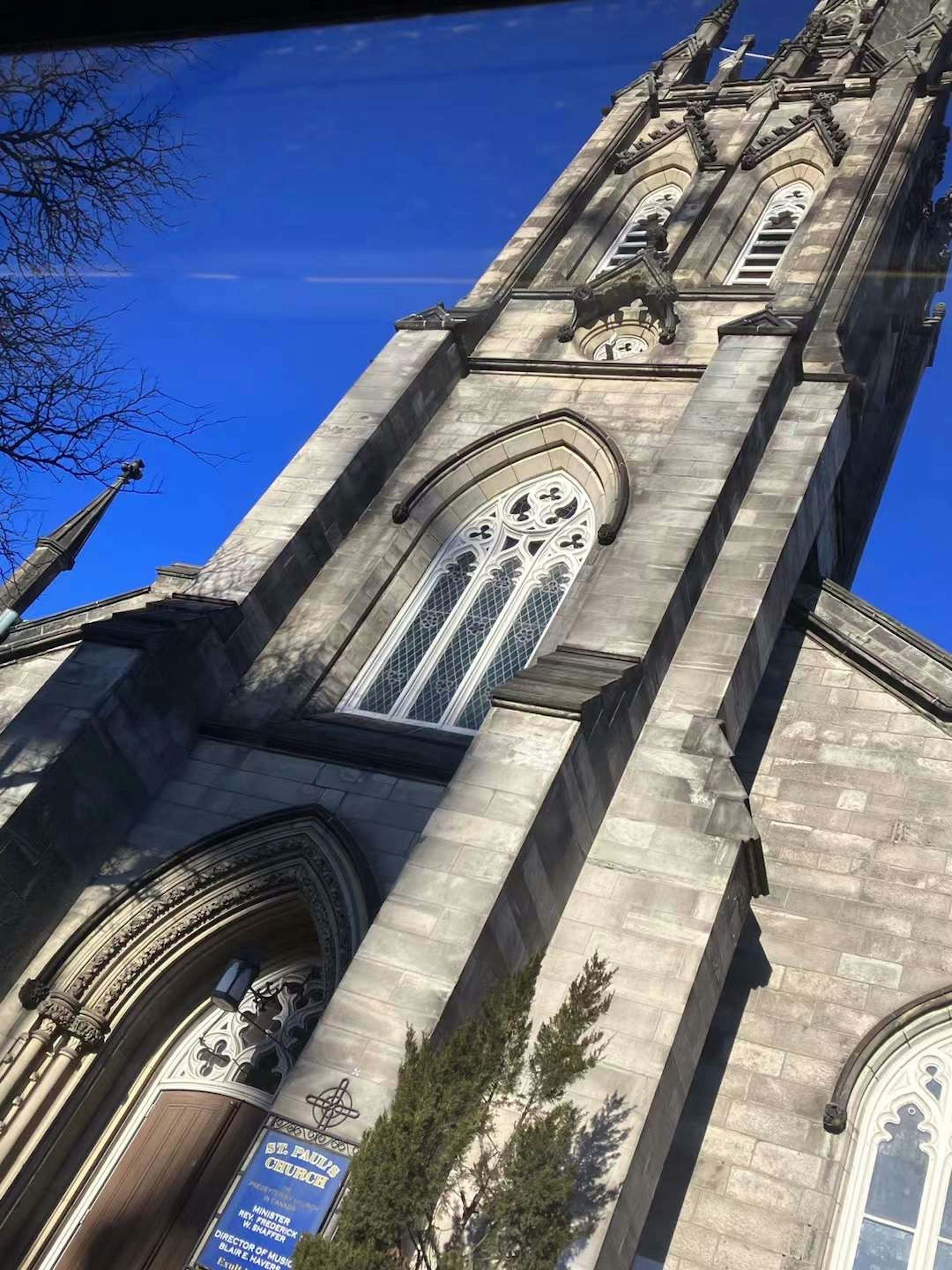 Gothic-style church tower with stone facade against a blue sky