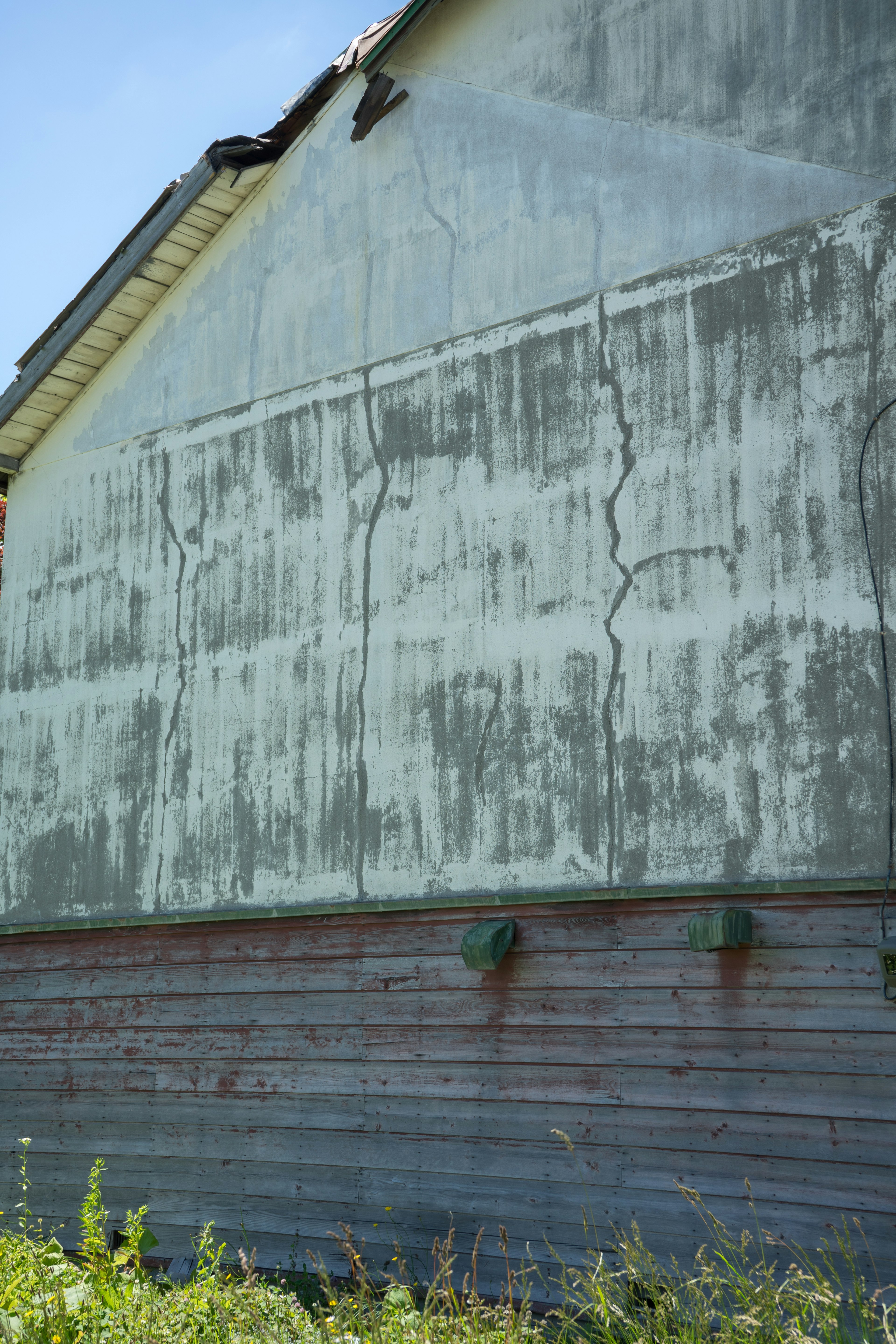 Cracked and weathered exterior wall of an old building