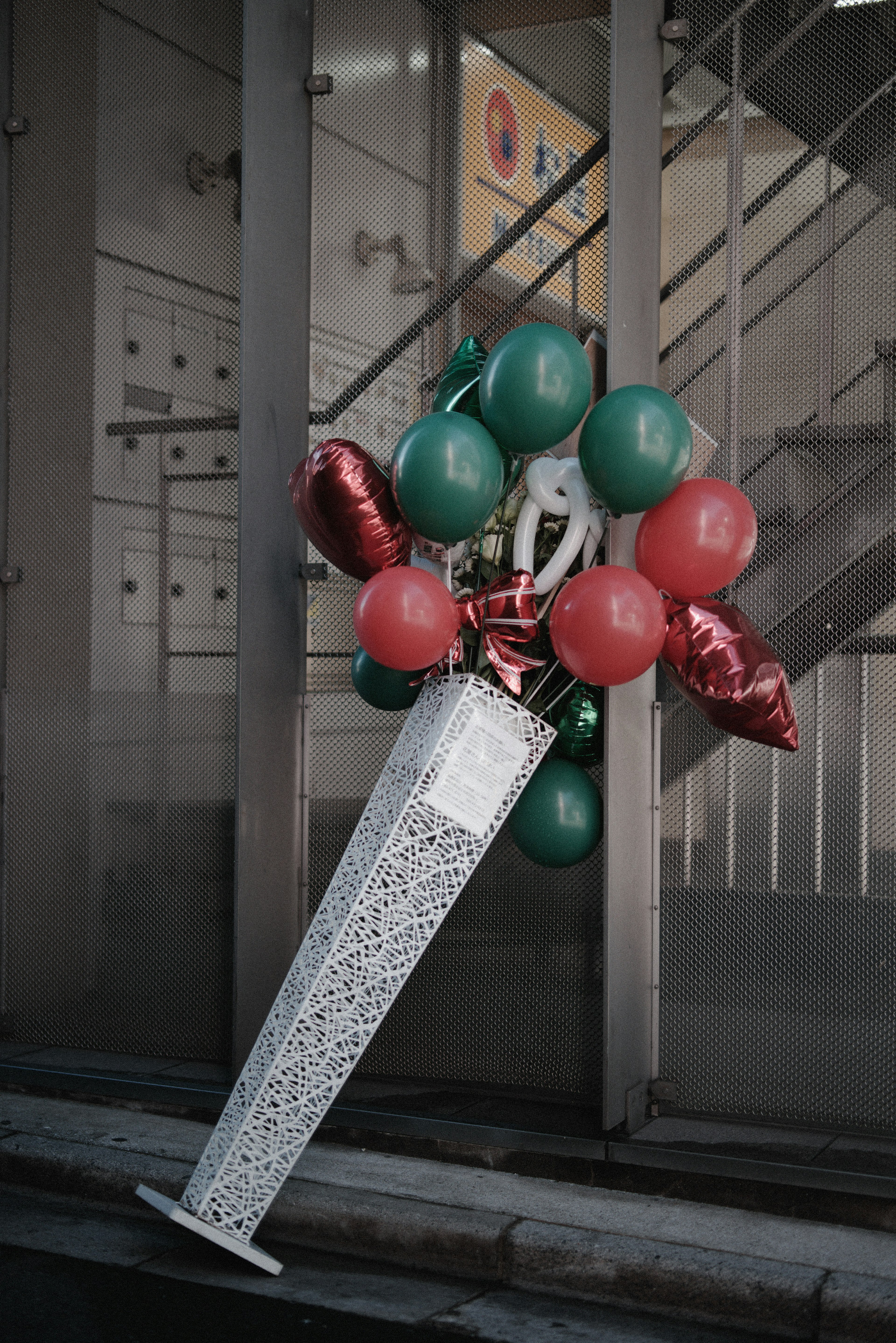 A bouquet-like object decorated with red and green balloons