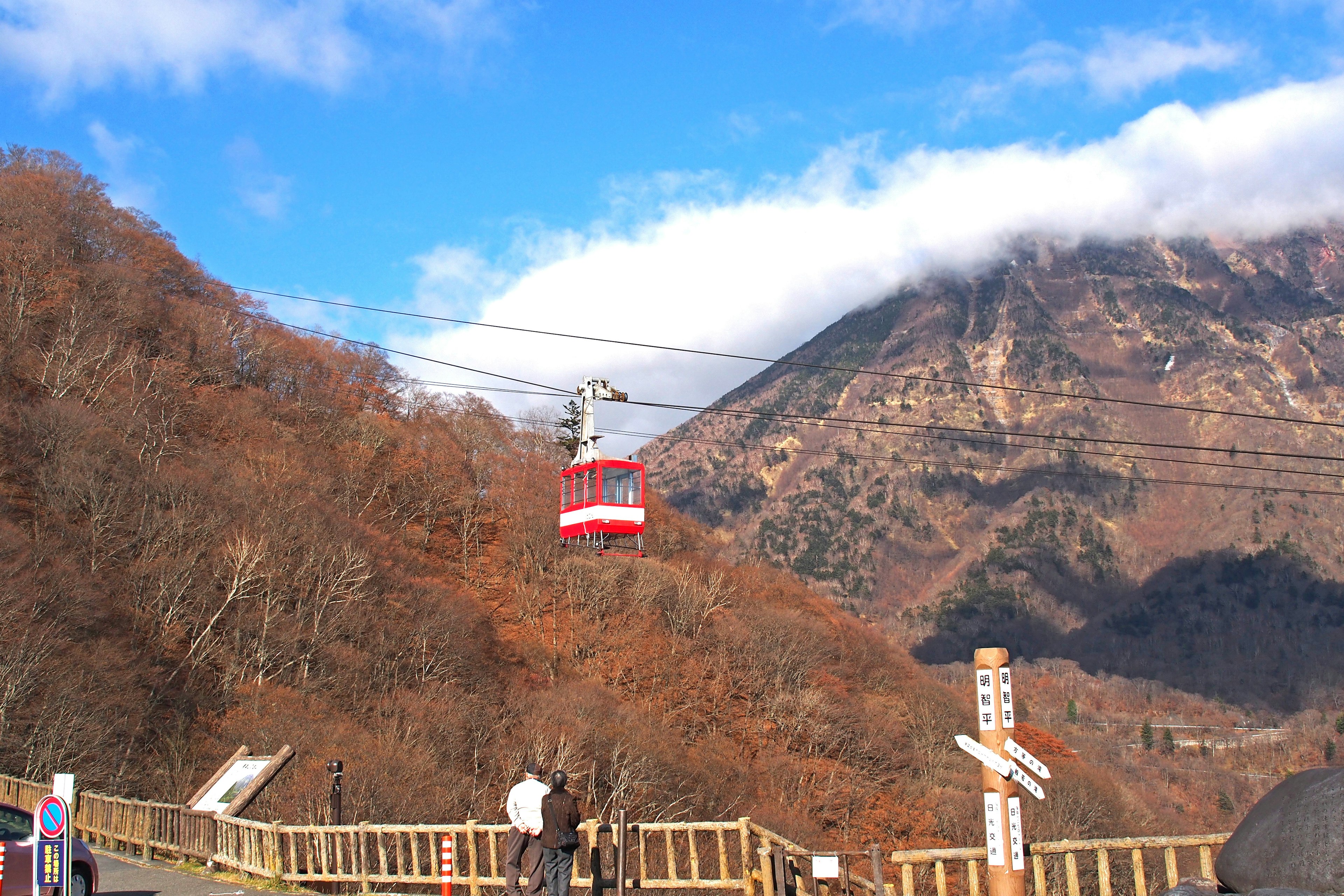 Rote Seilbahn, die Berge unter einem blauen Himmel überquert