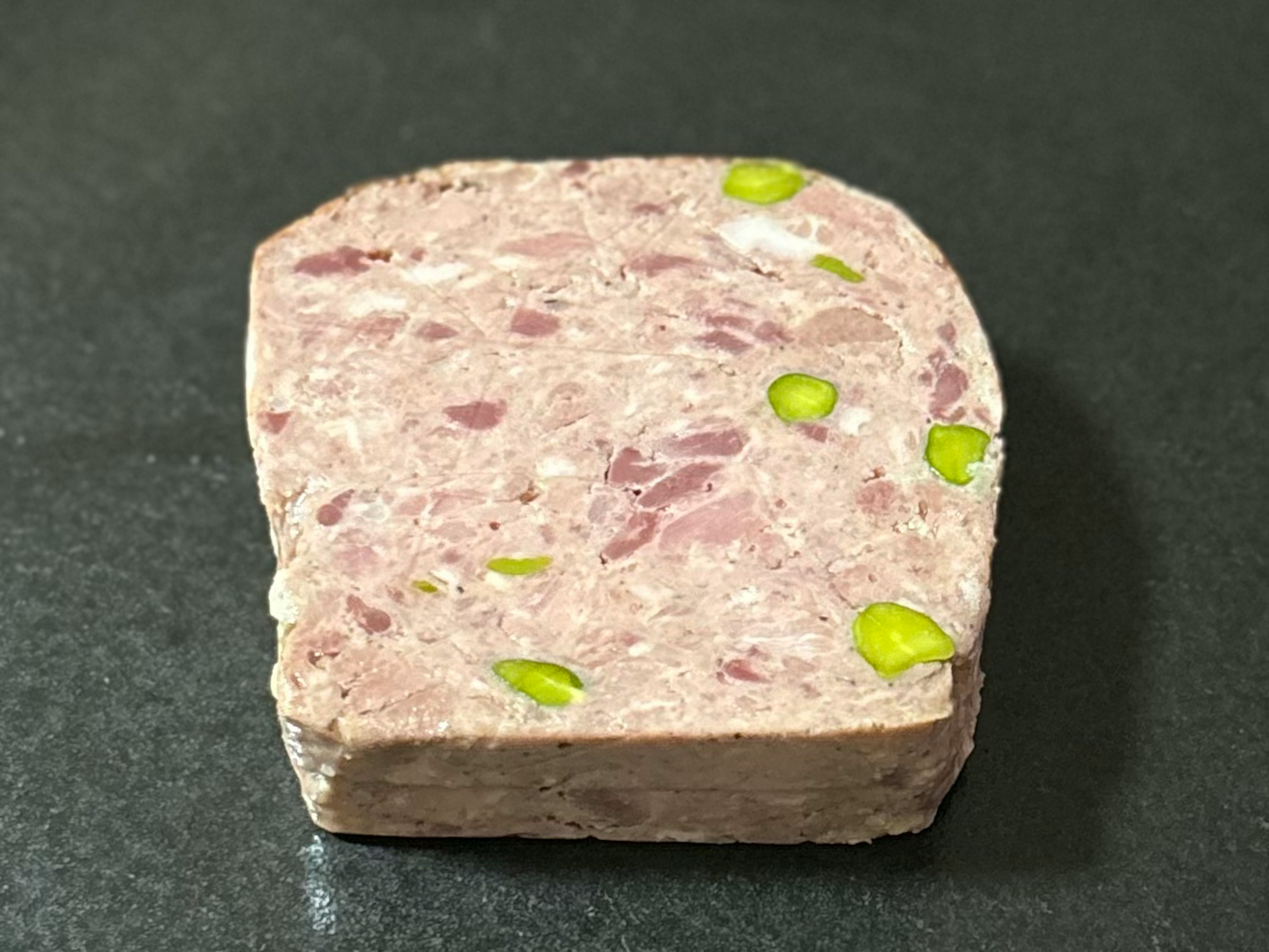 Sezione di terrina di carne con pistacchi verdi sparsi