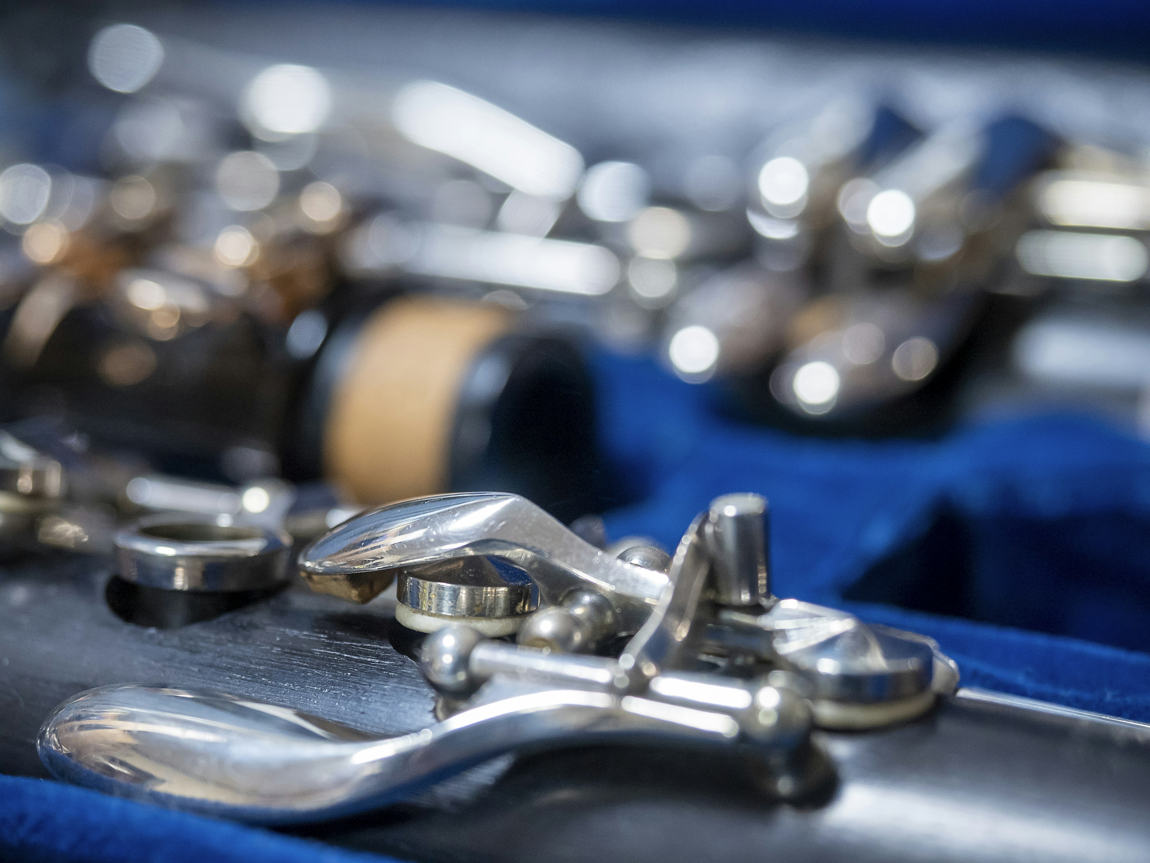 Close-up of flute keys on a blue fabric background