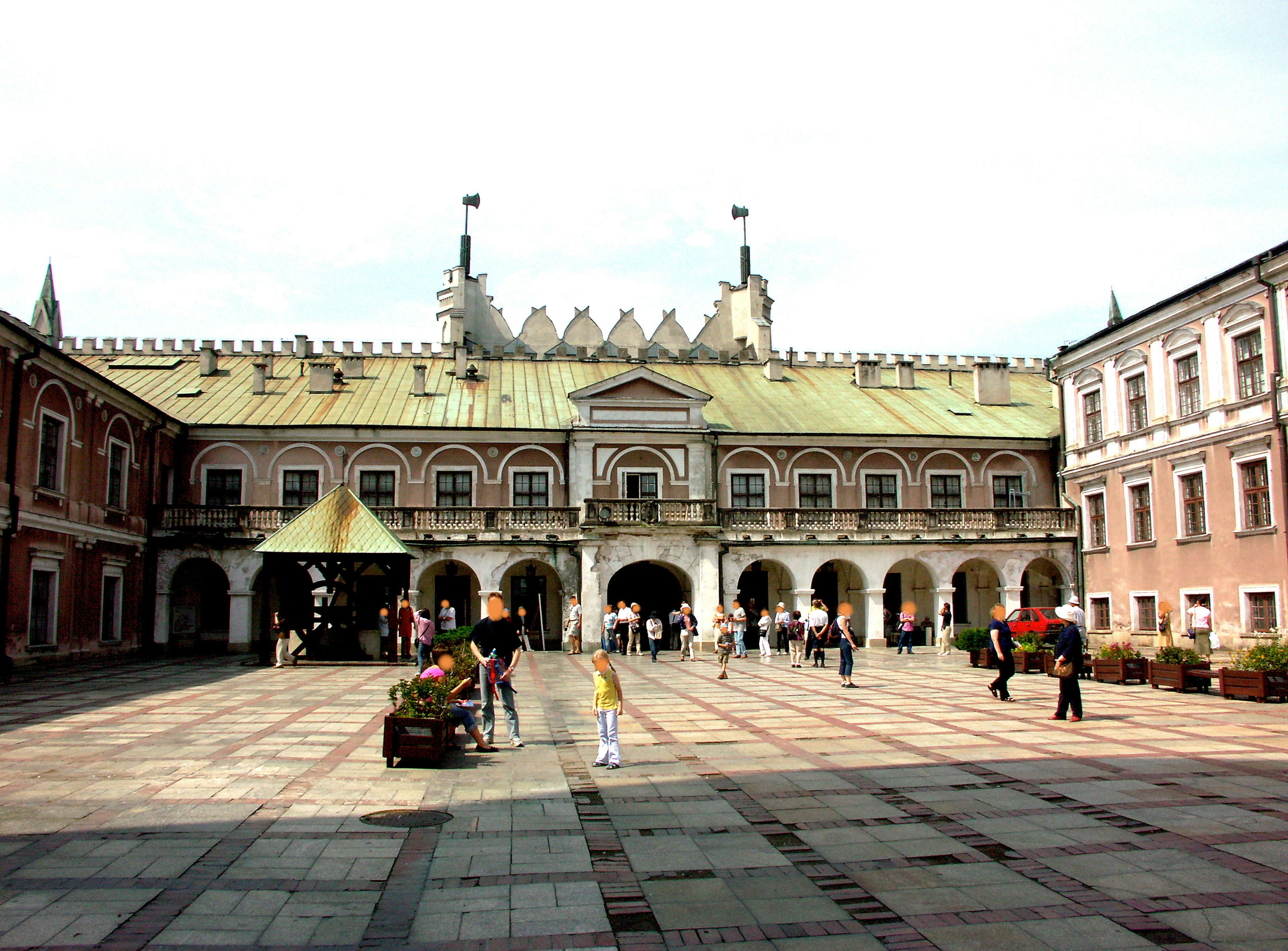 Tourists gathering in a square with historical buildings