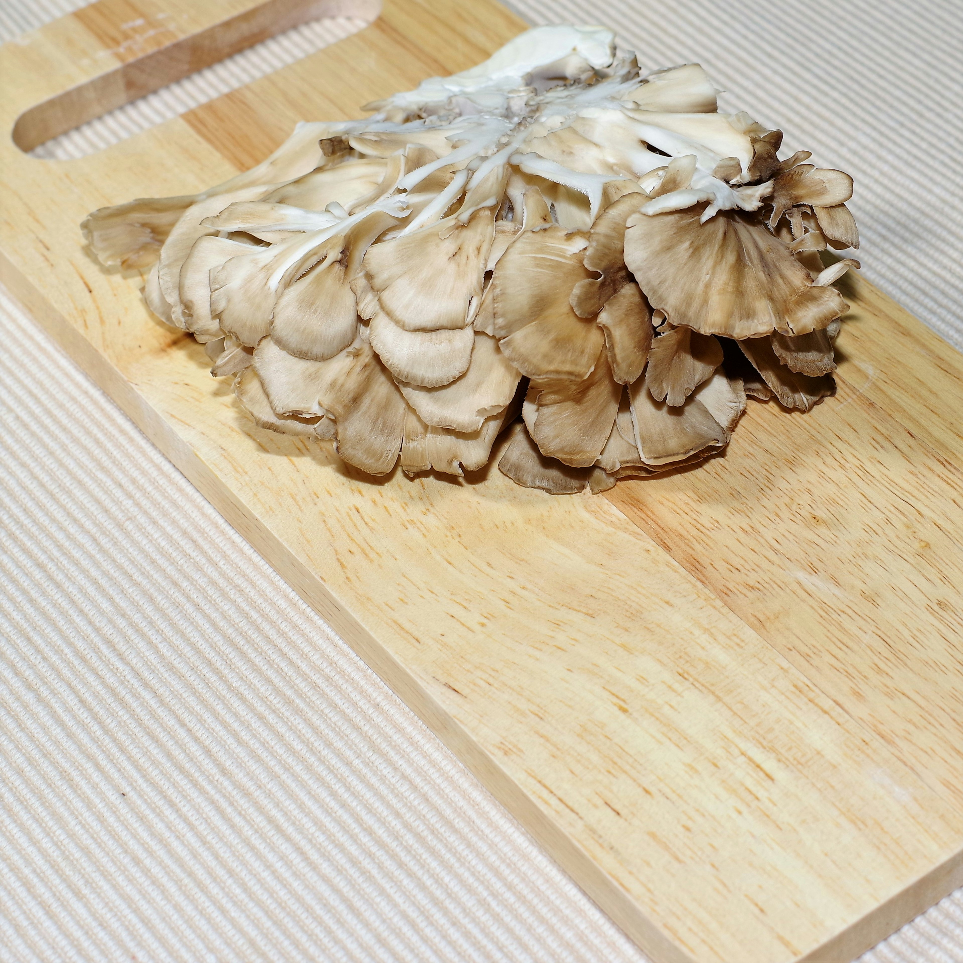 Brown mushroom placed on a wooden cutting board