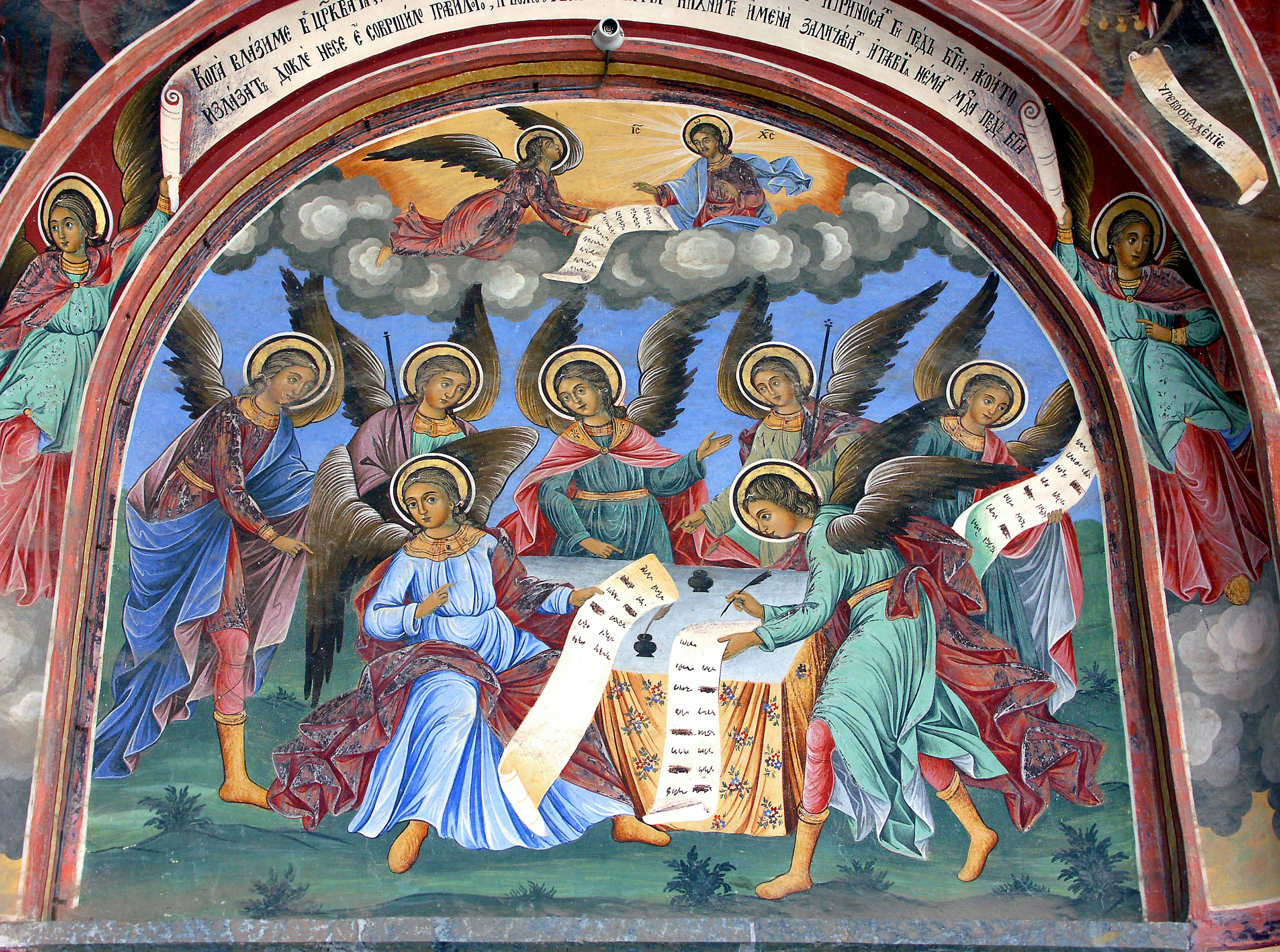 Beautiful religious mural depicting angels gathering around a scroll