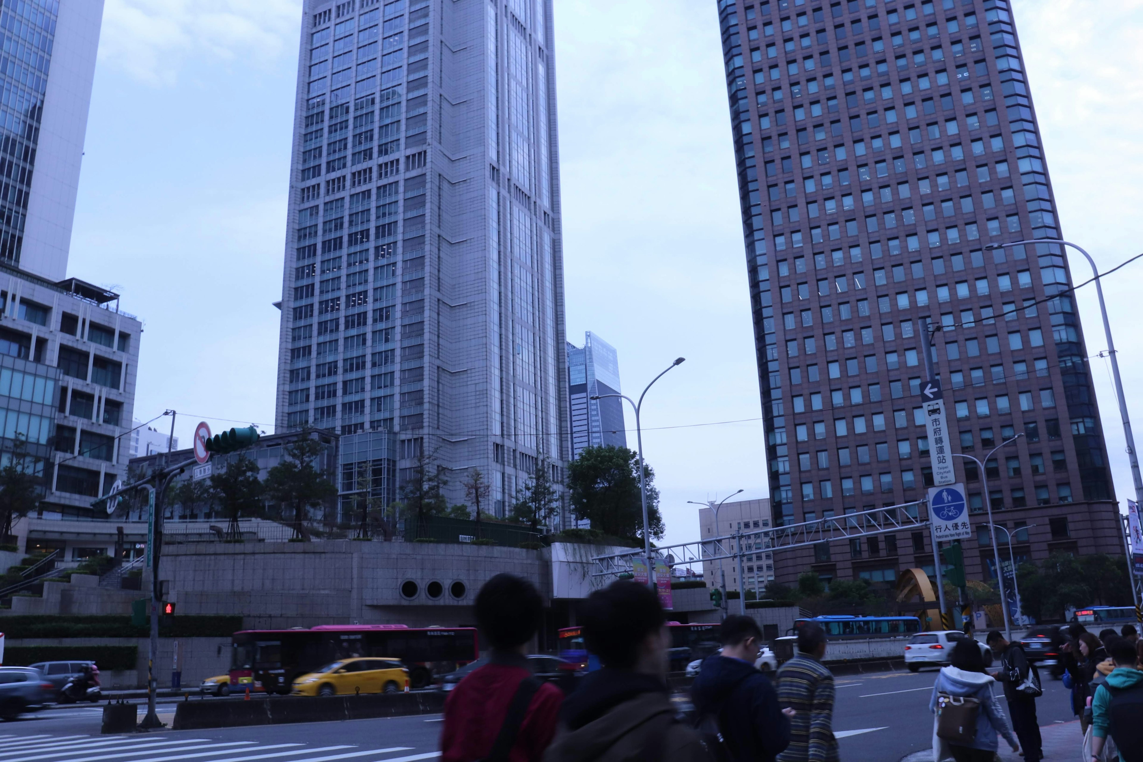 Urban landscape featuring tall buildings and a crowd of people