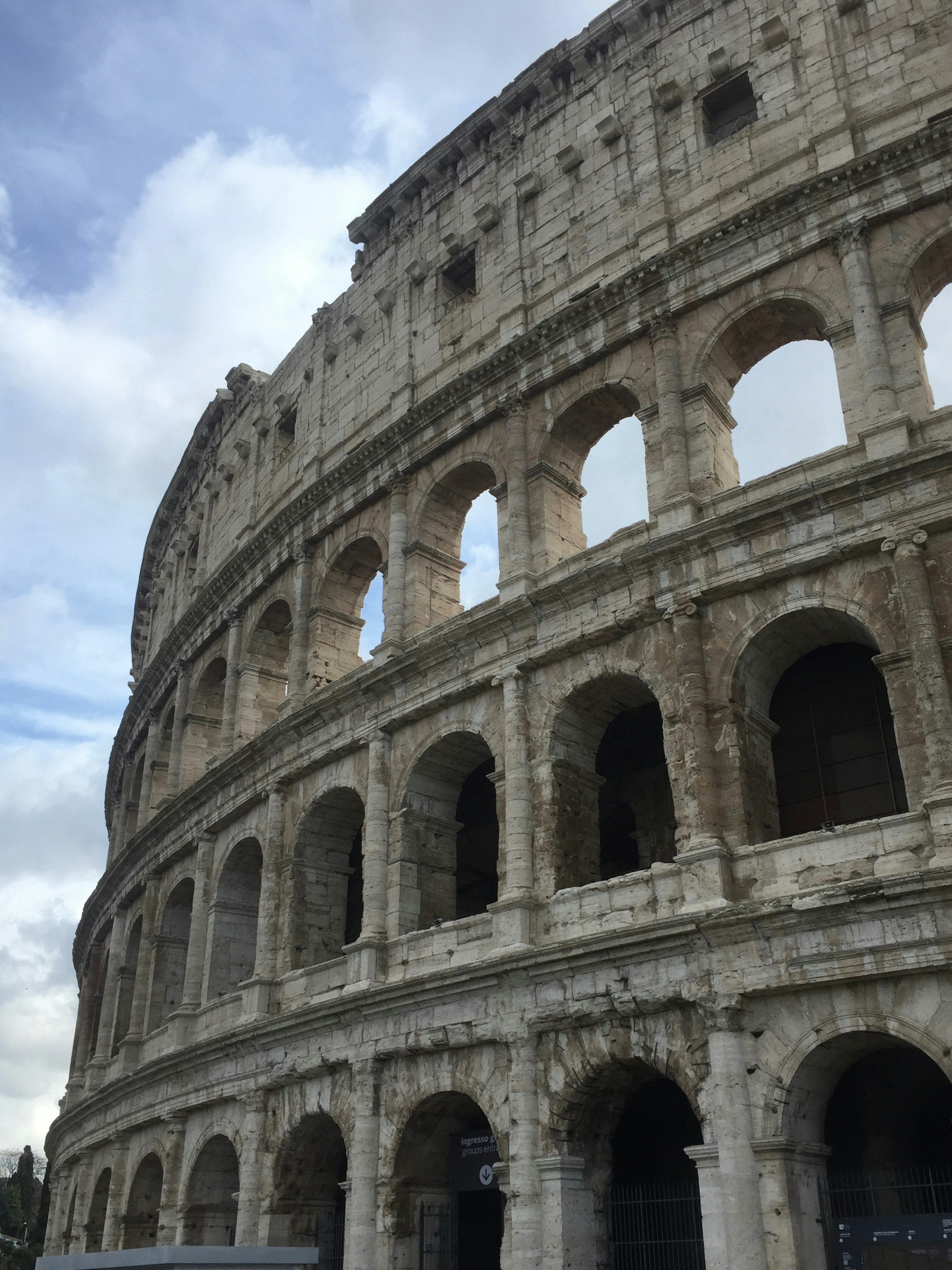 Góc nhìn bên của Đấu trường Colosseum ở Rome với bầu trời nhiều mây