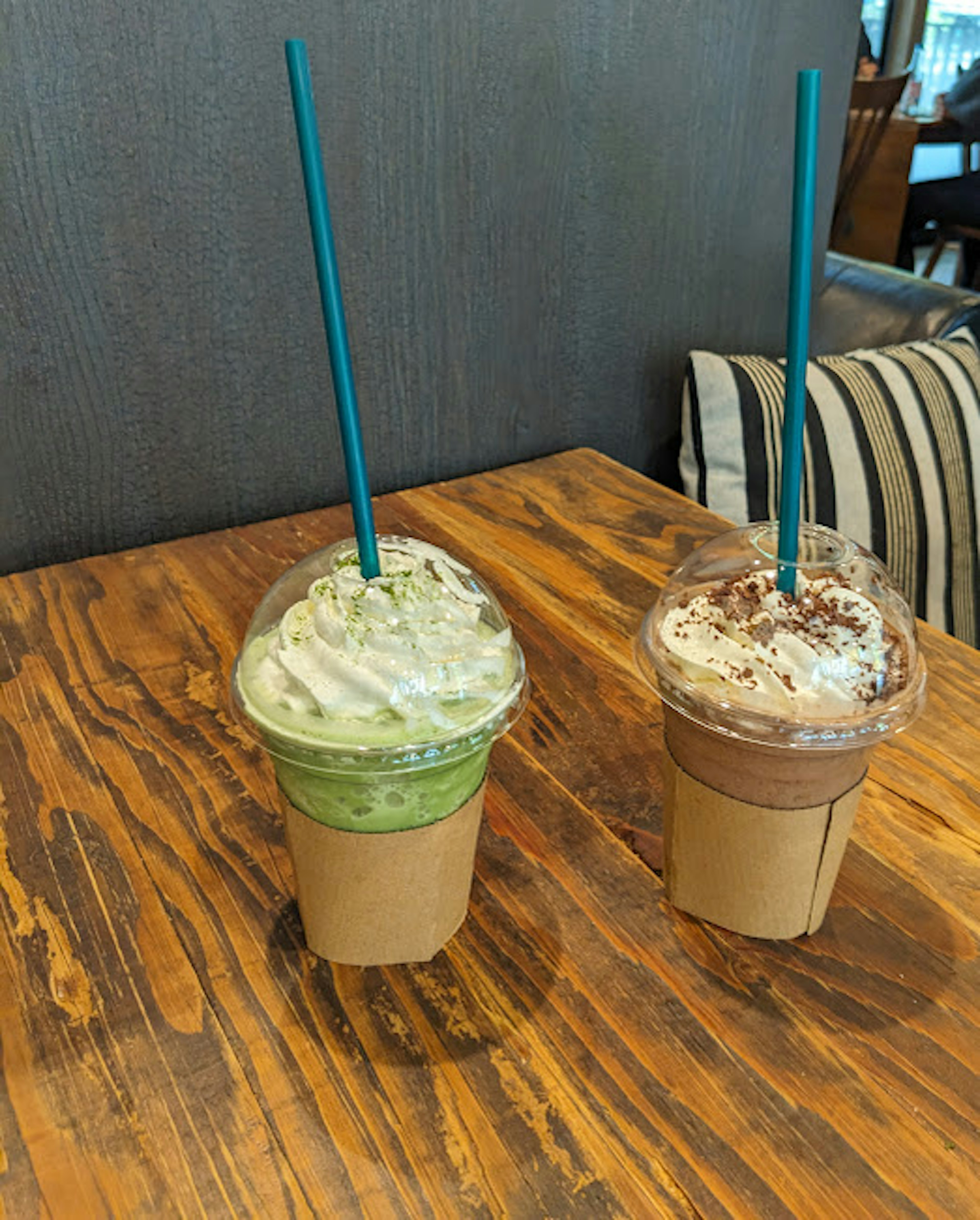 Green tea and chocolate frappuccinos on a wooden table