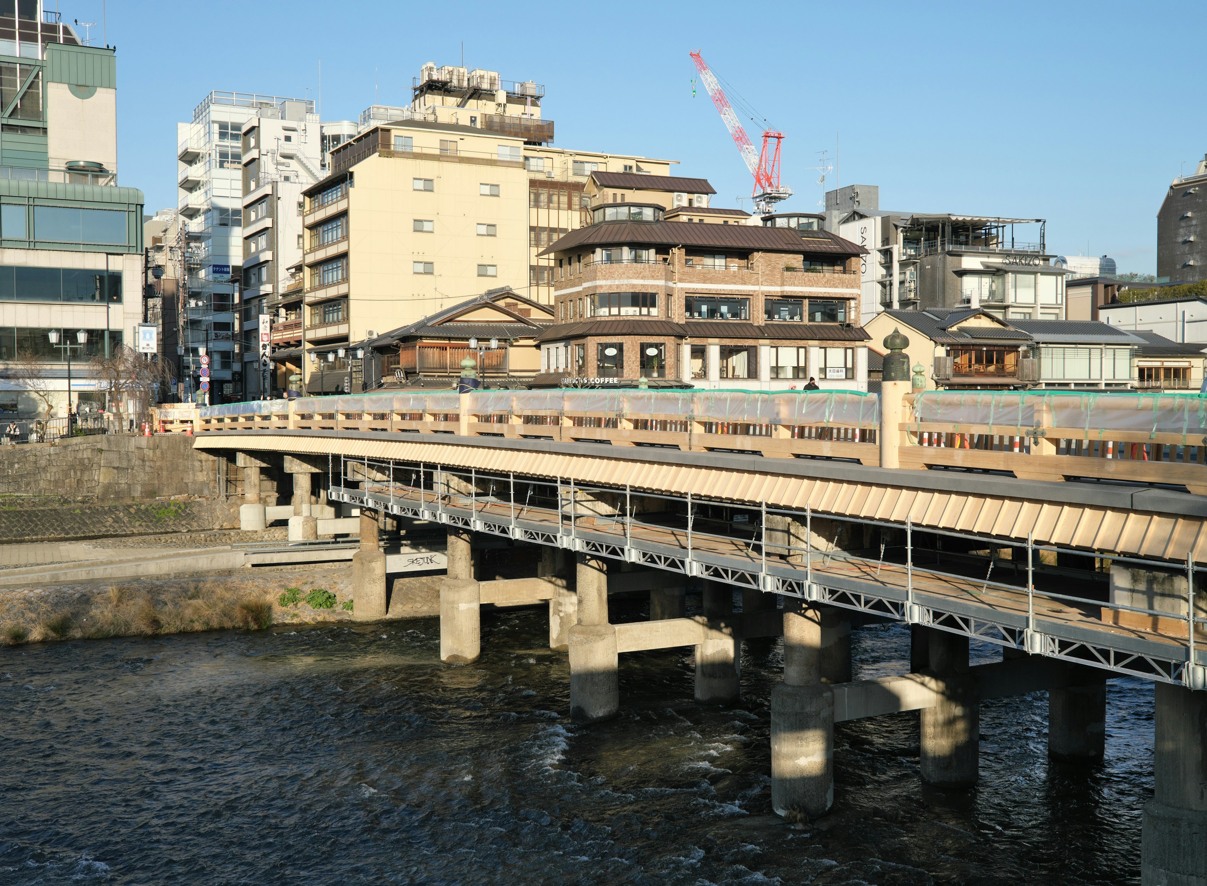 A bridge over a river with adjacent buildings