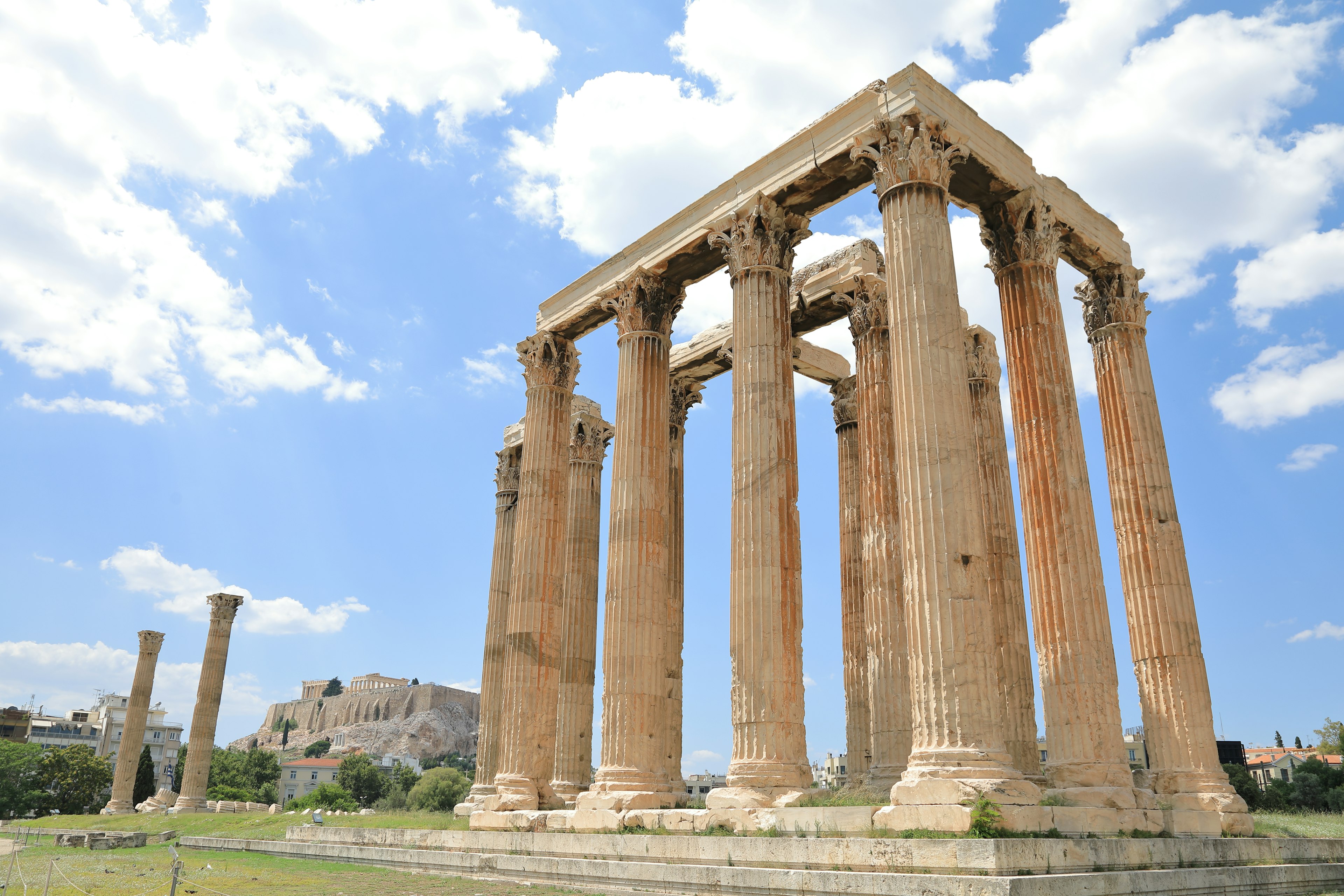 Ancient temple columns standing under a blue sky