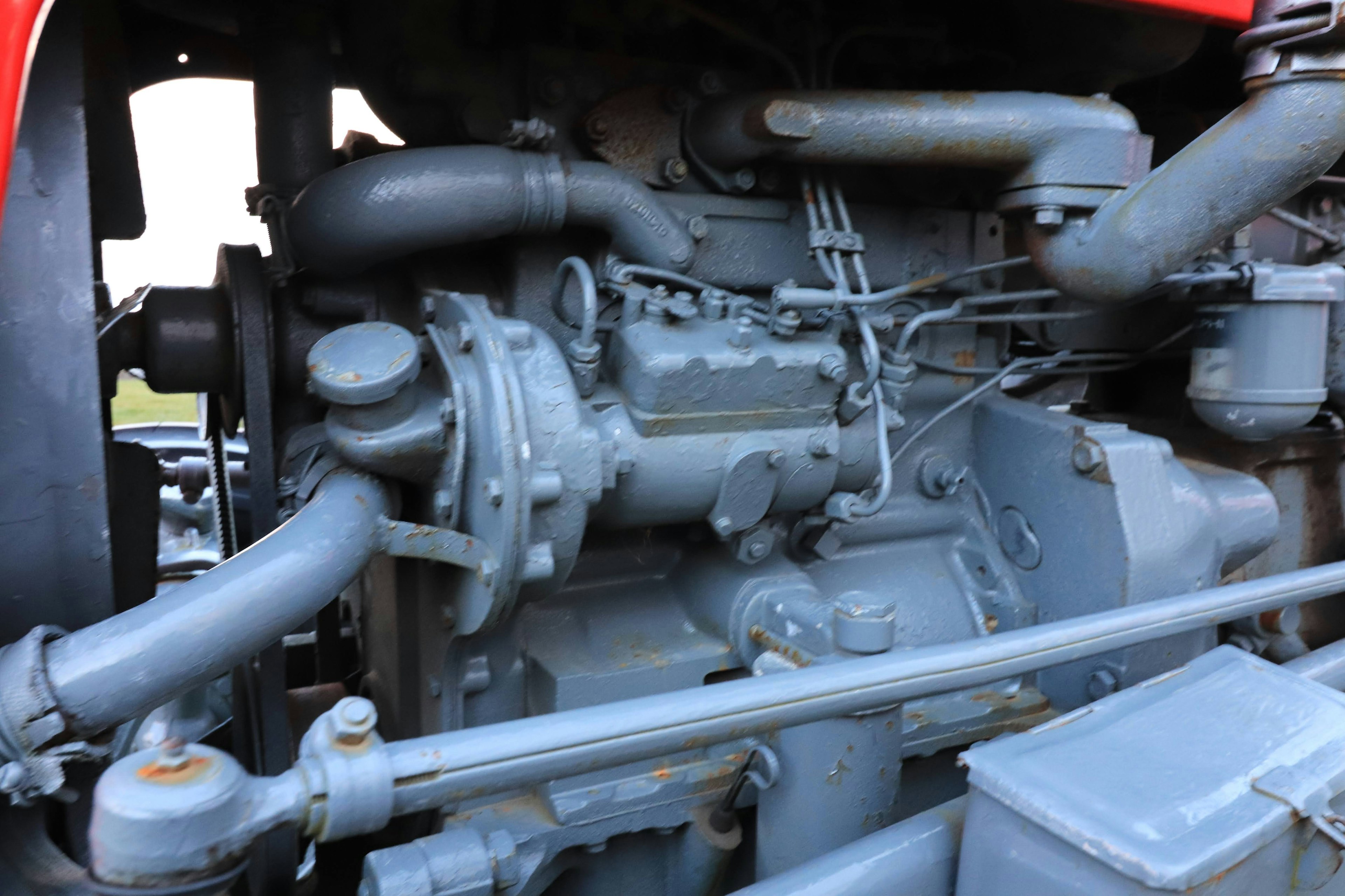 Detailed view of the engine compartment of a red tractor