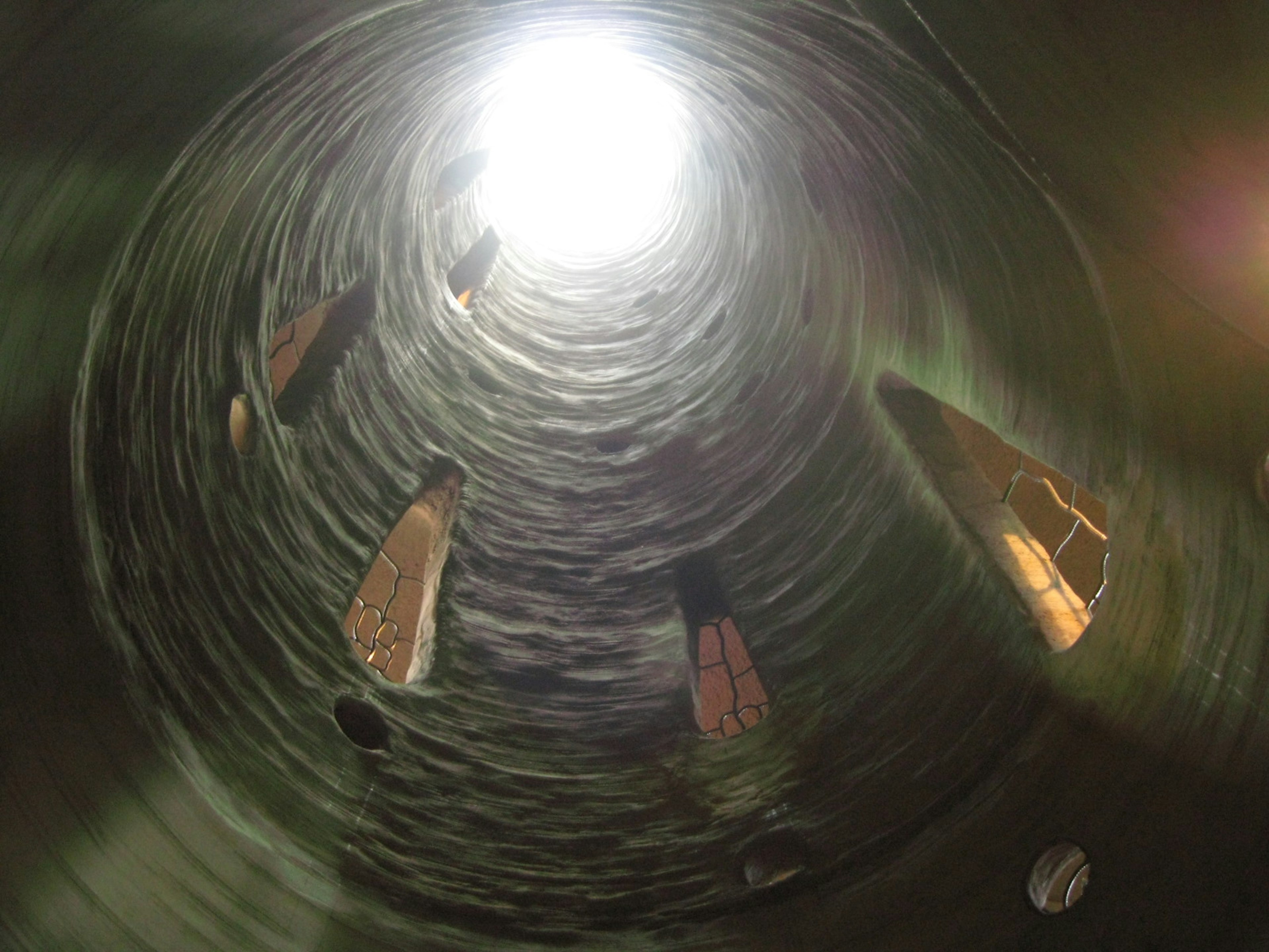 Interior view of a cylindrical structure with light streaming from above