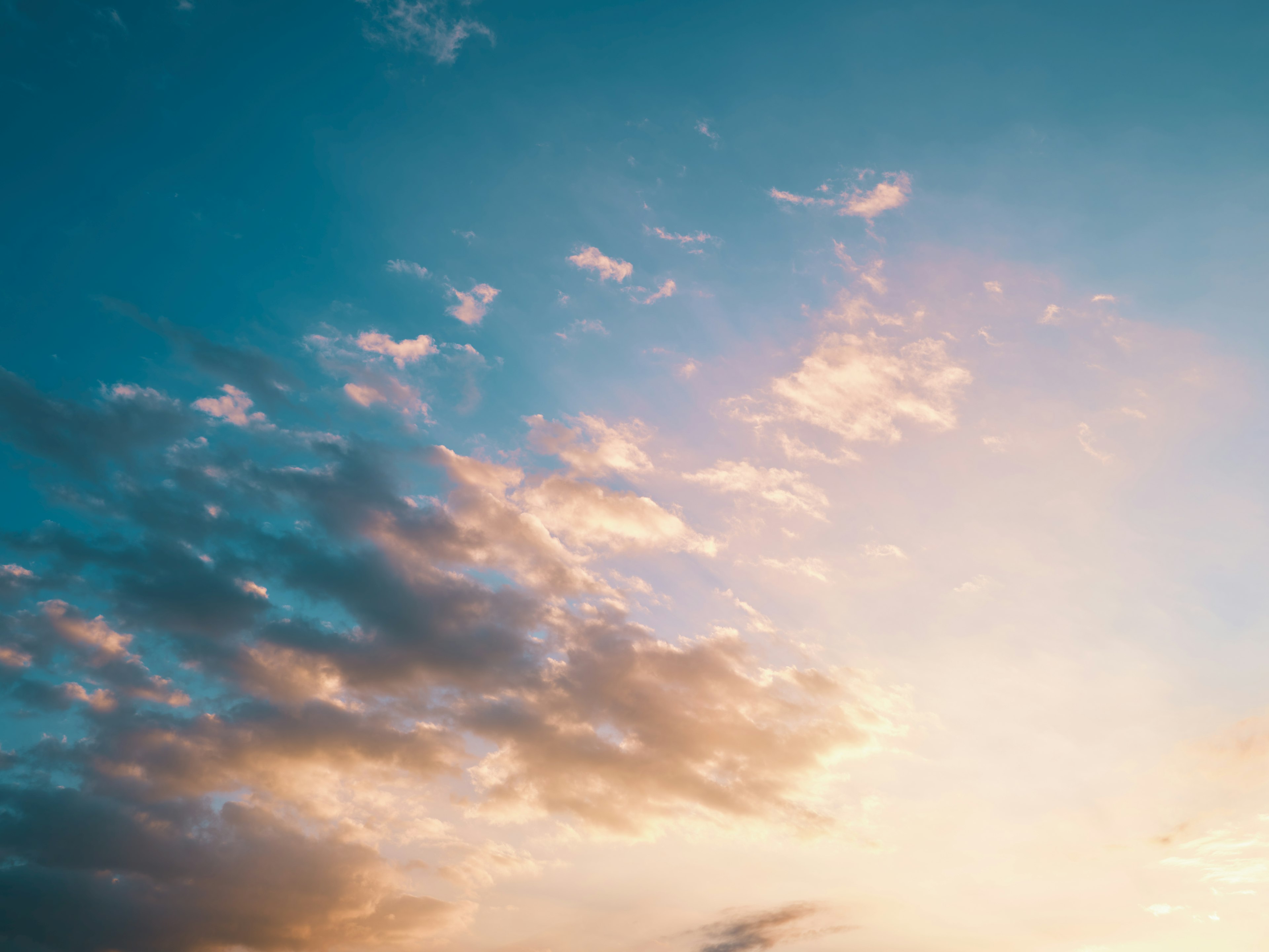 Soft clouds in a blue sky with warm light