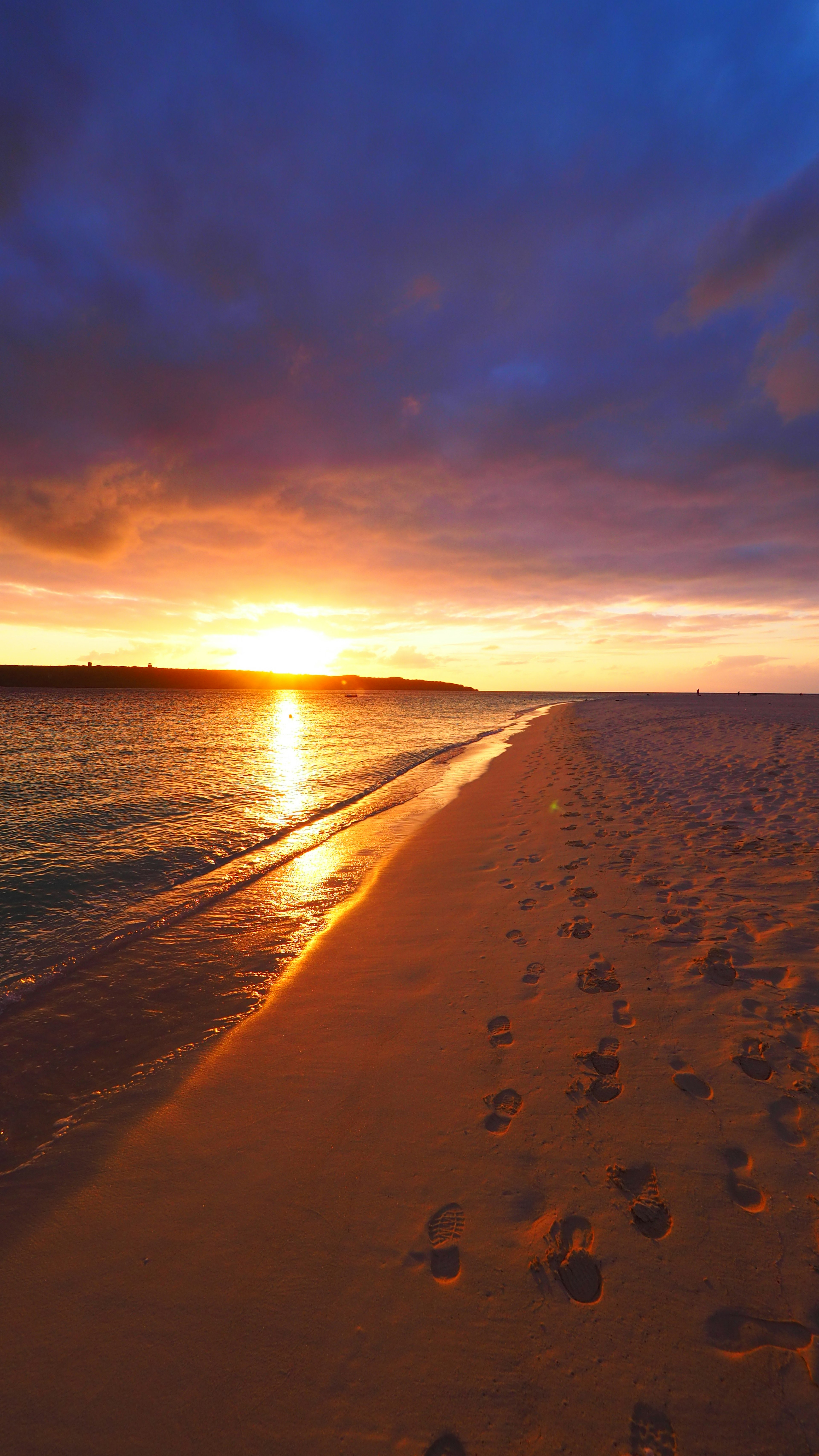 Beautiful sunset over the ocean with sandy beach