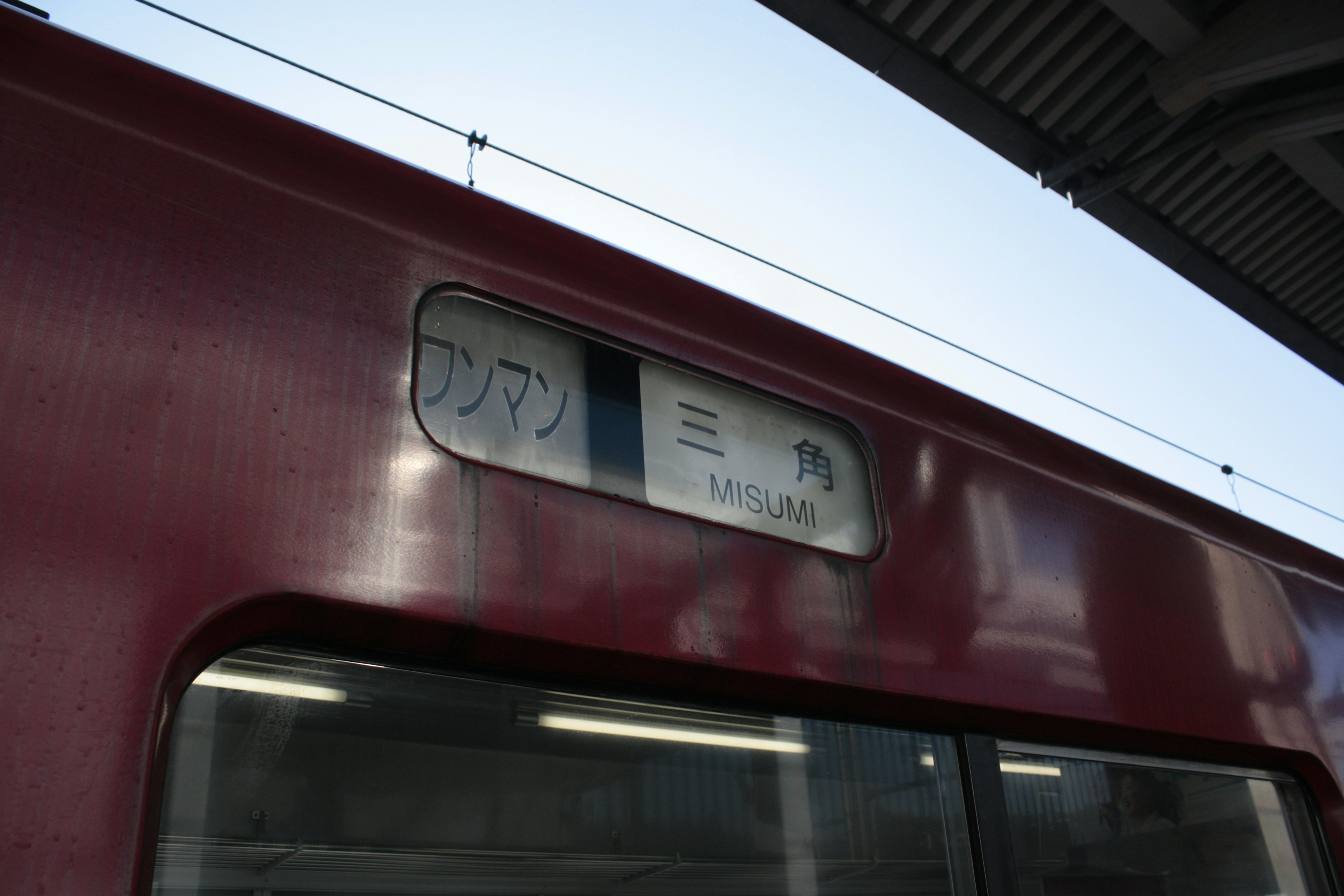 Image d'un wagon de train rouge avec un panneau de destination