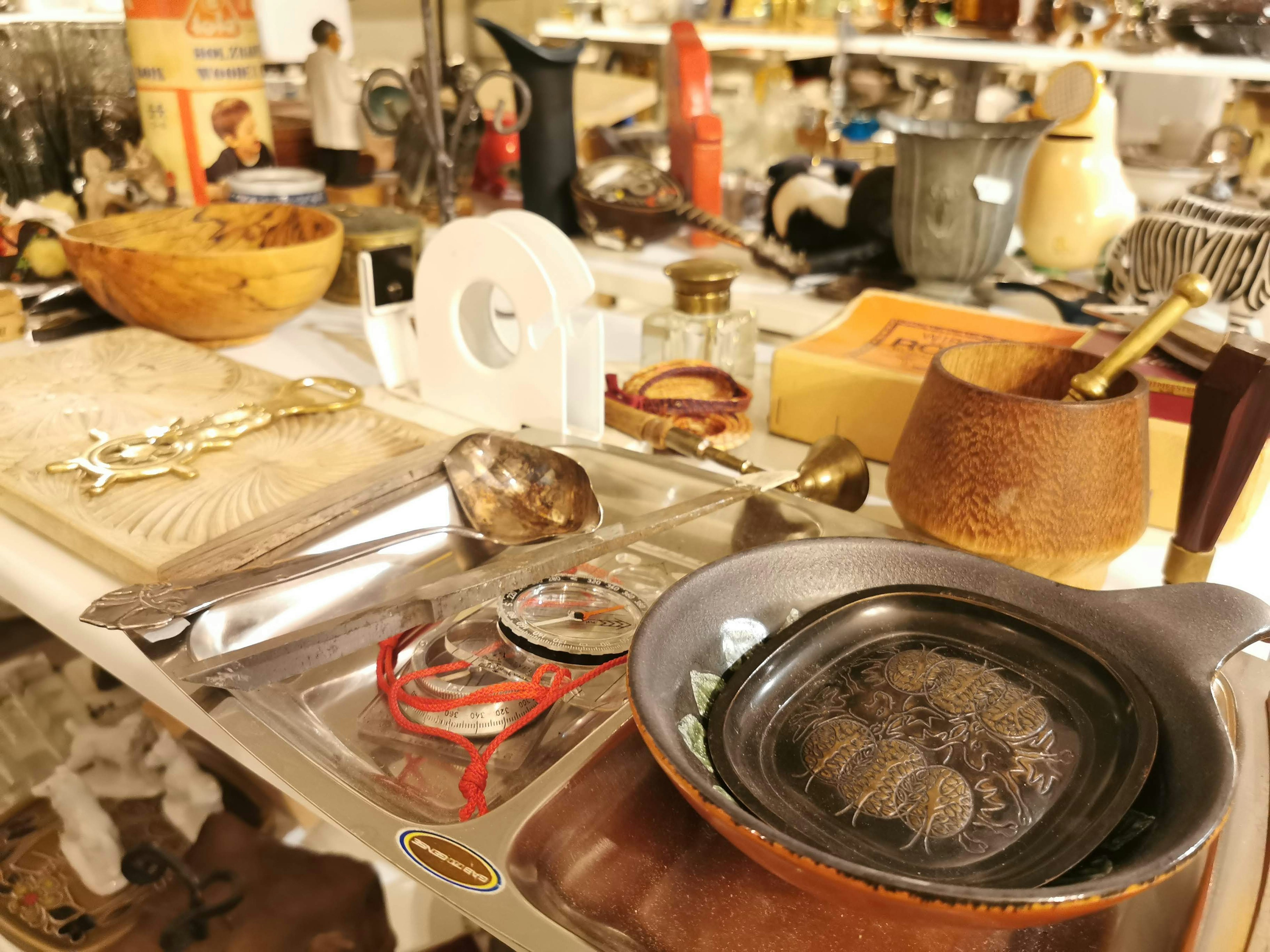 A tabletop filled with various antiques and collectibles